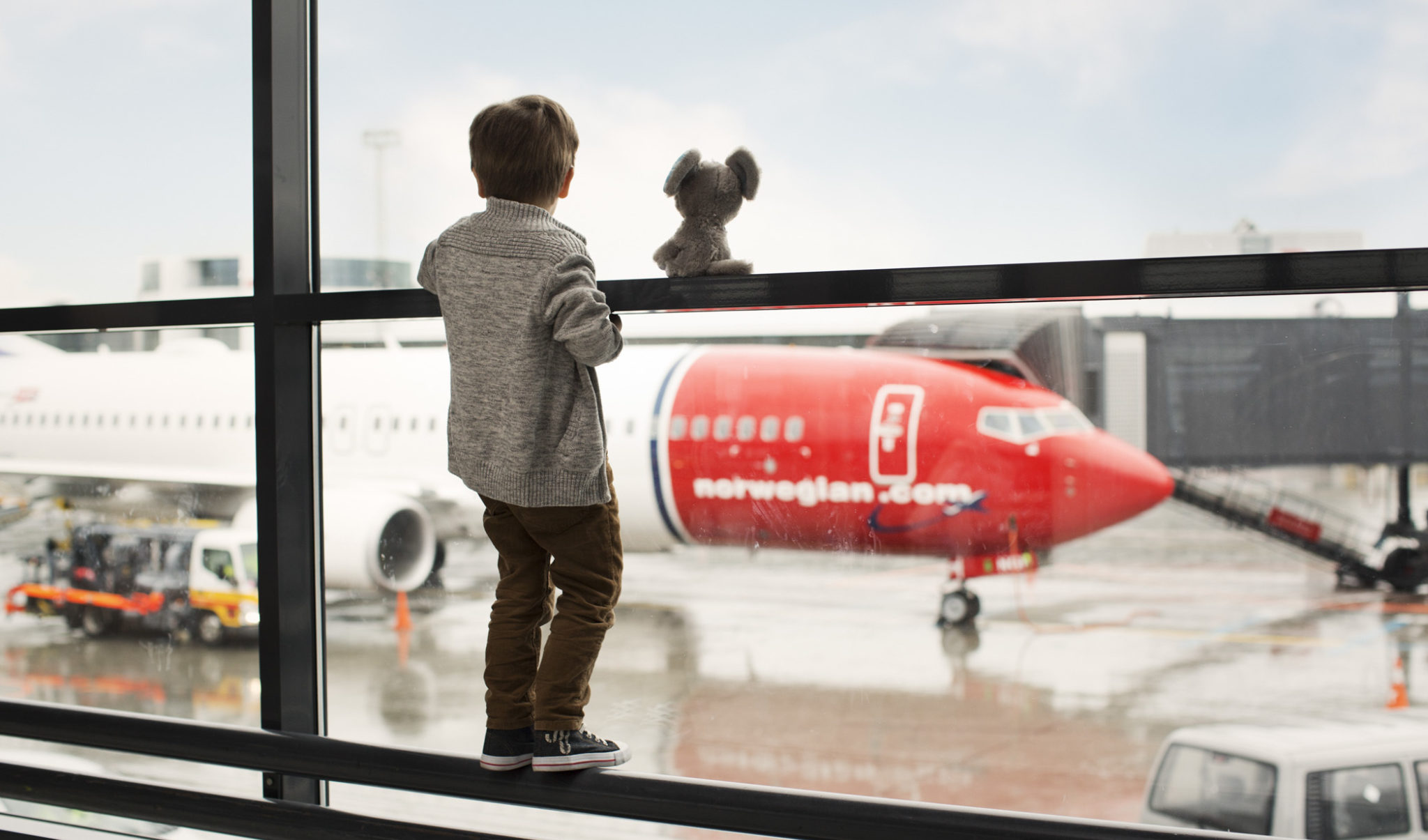 Little Boy Looks Out At Norwegian Plane Little Boy Looks Out At Norwegian Plane