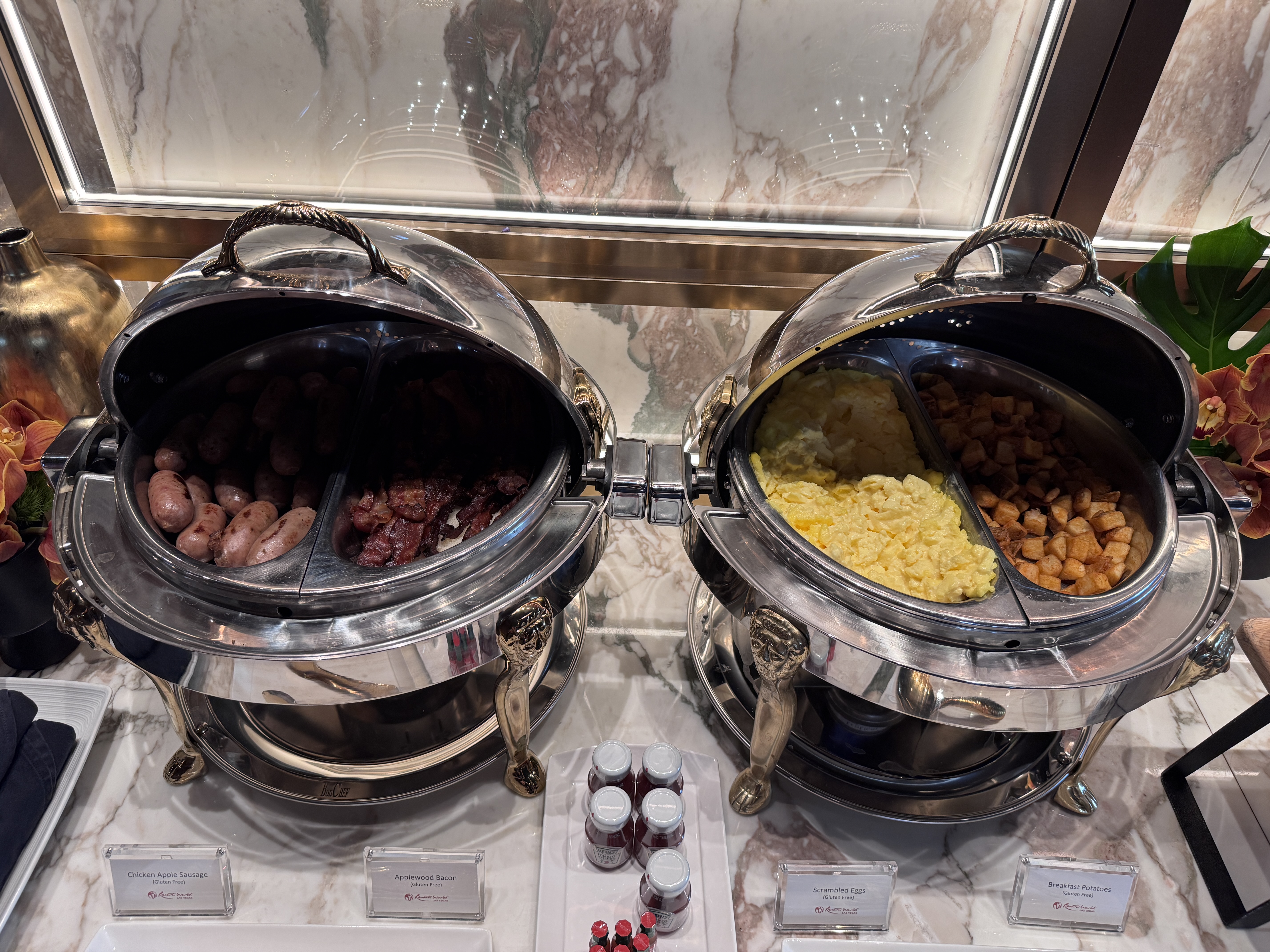 Conrad Las Vegas Club 66 breakfast chafing dishes with sausage eggs and potatoes