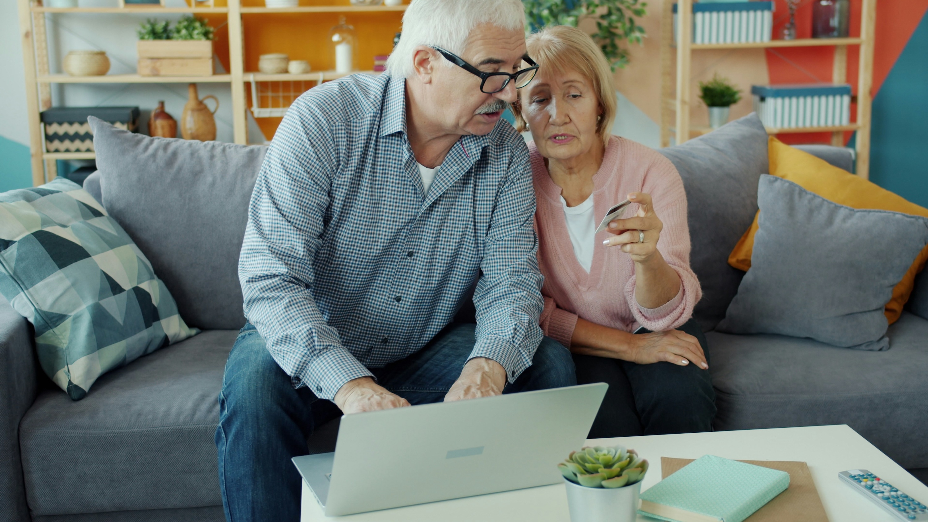 Couple with credit card laptop sofa Couple with credit card laptop sofa