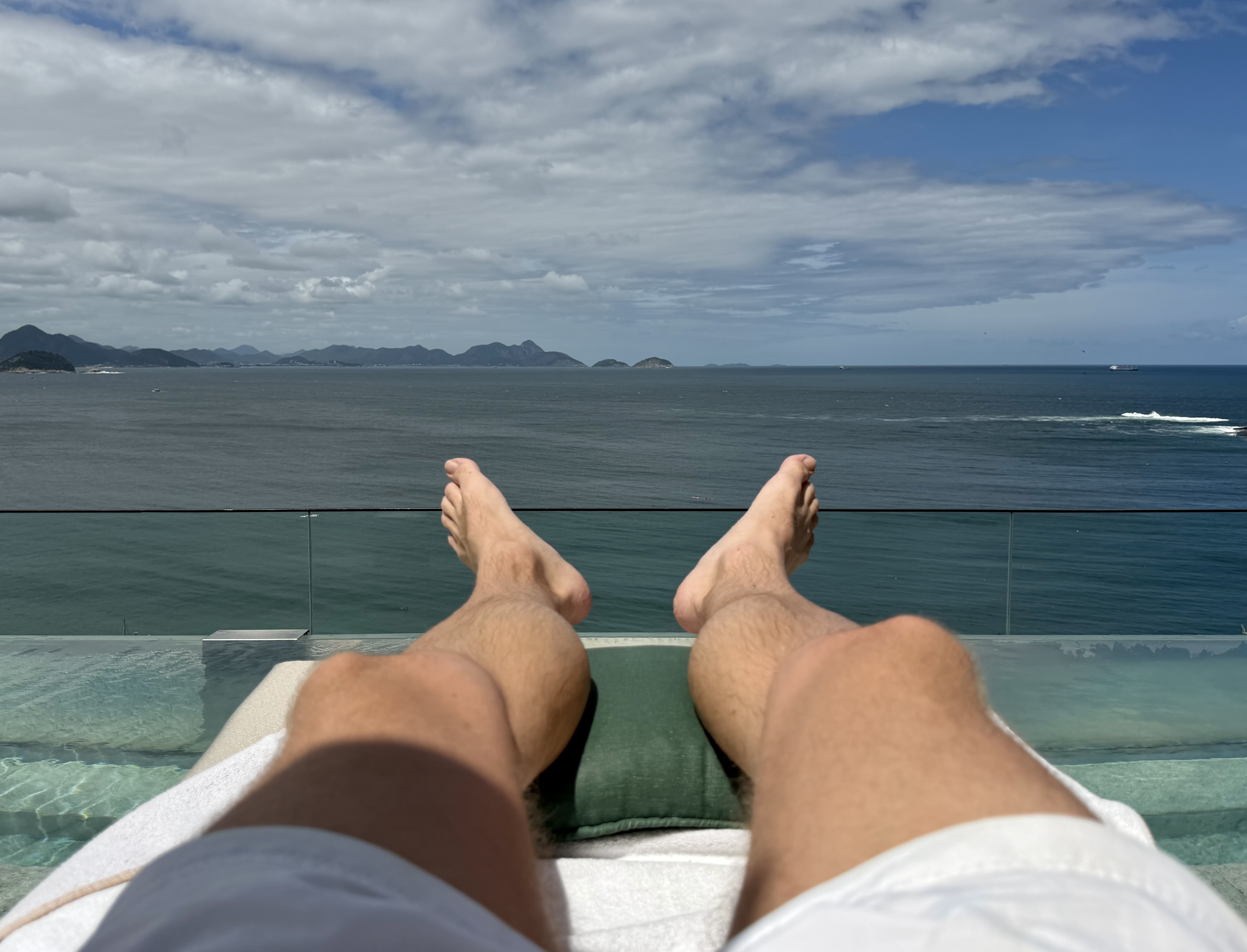 Emiliano Rio sunbathing by rooftop pool