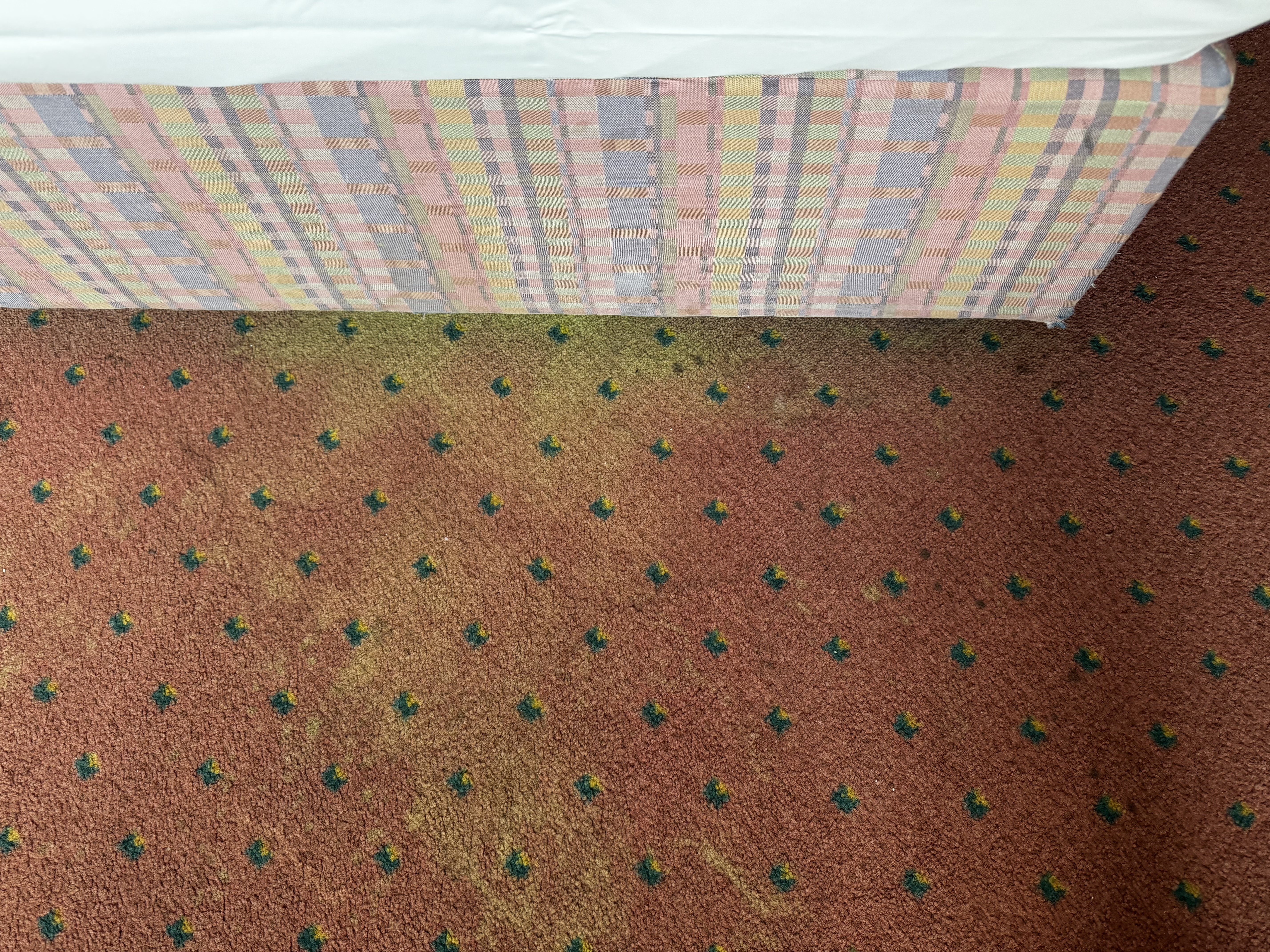 Four Essen faded carpet by bed