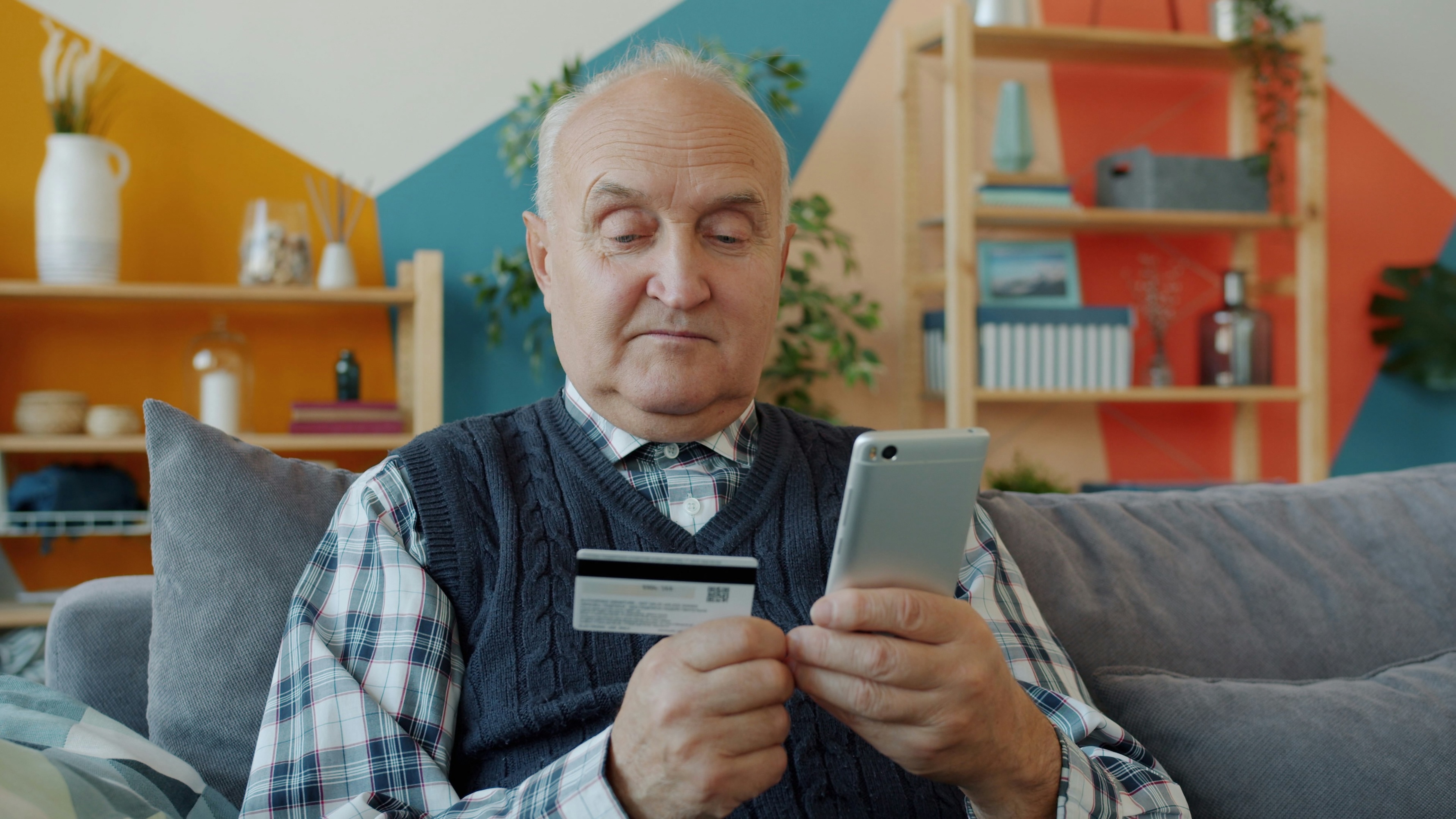 Senior elderly man with phone credit card Senior elderly man with phone credit card