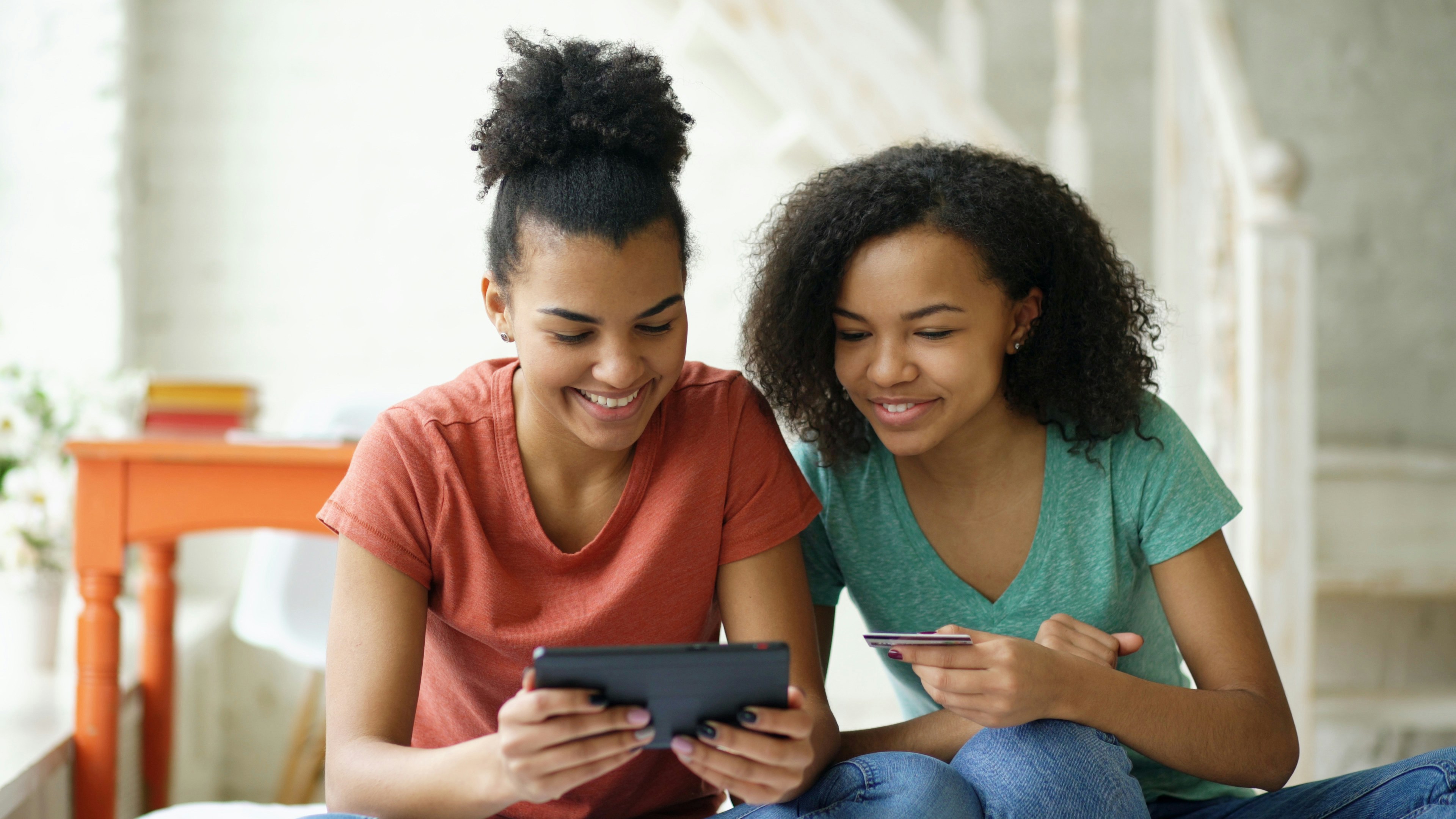 Young women with tablet and credit card