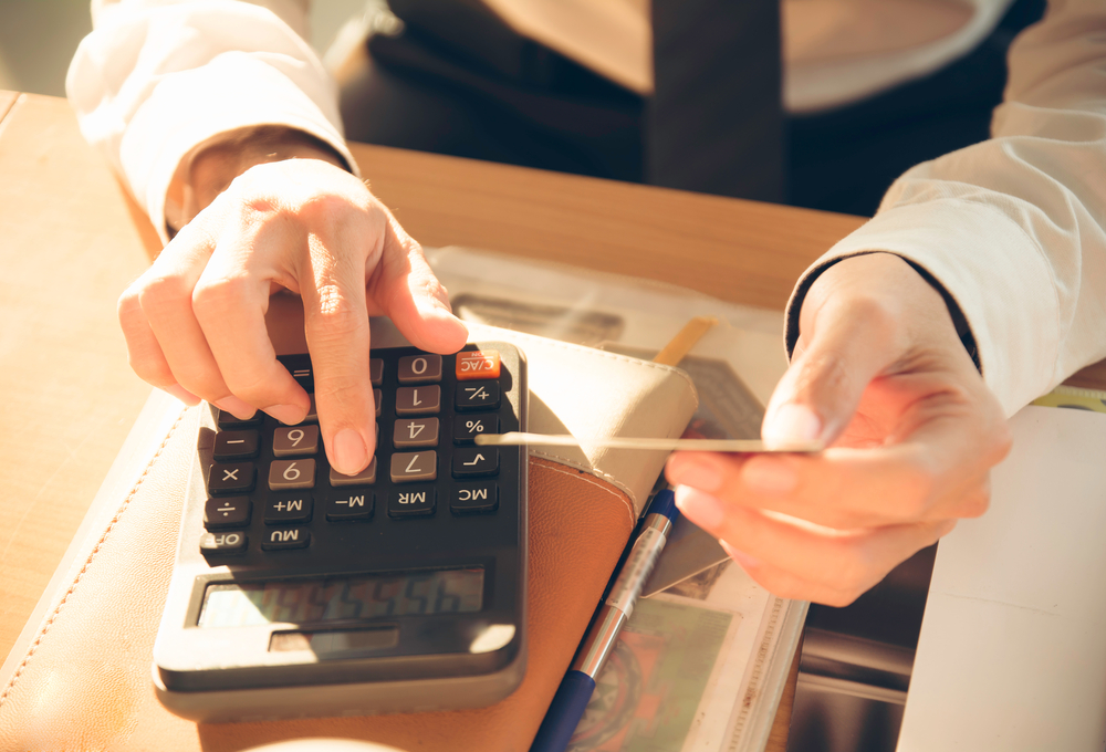 Young man and calculator
