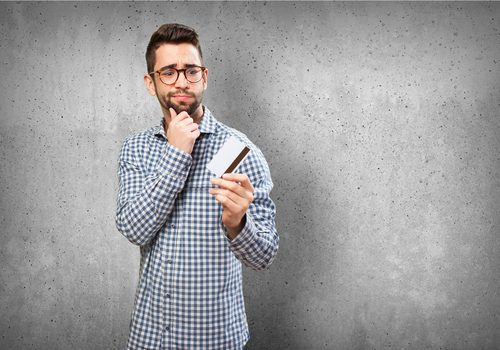 man thinking about credit card