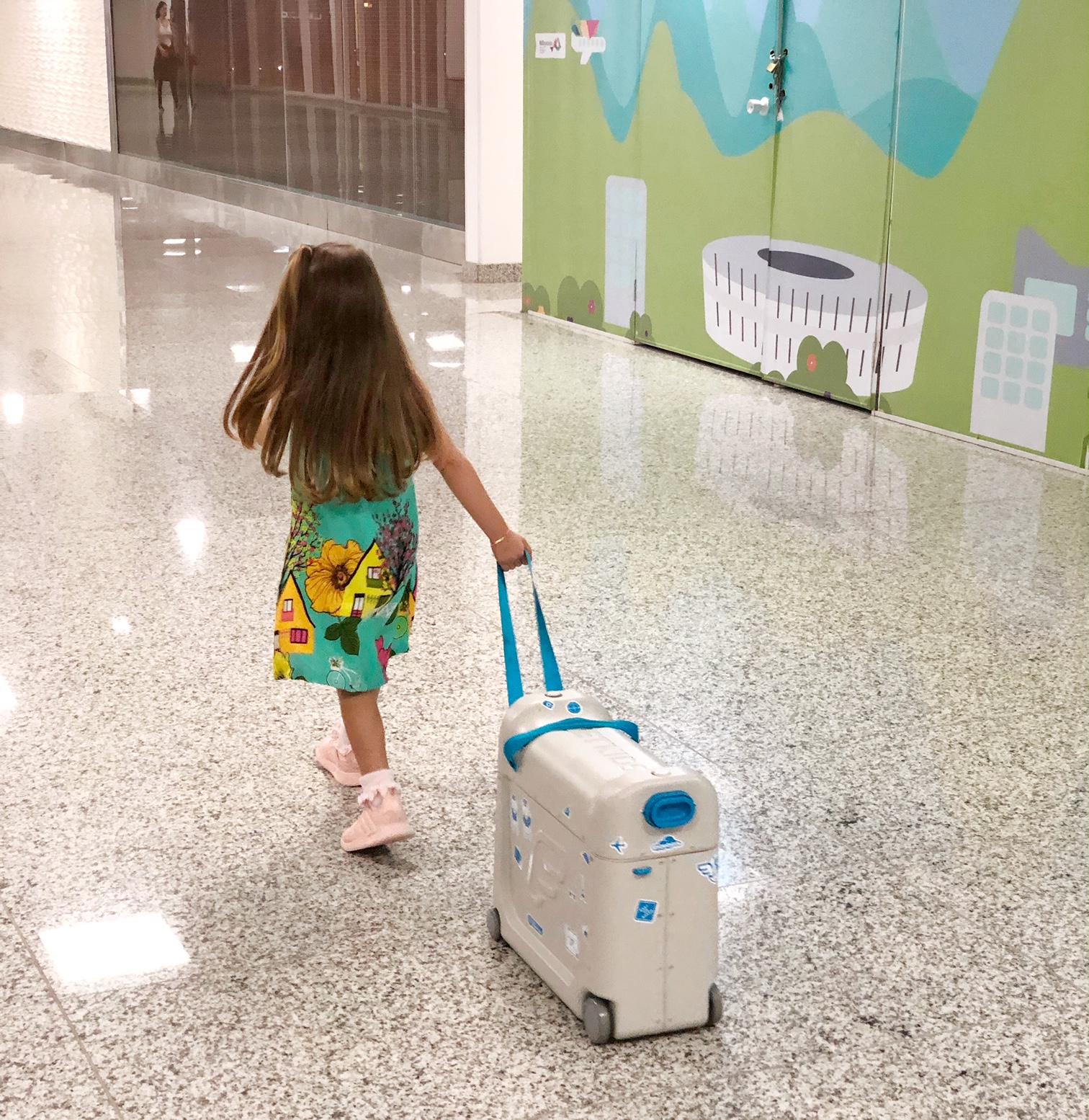 Little Girl Pulling Luggage In The Airport Little Girl Pulling Luggage In The Airport