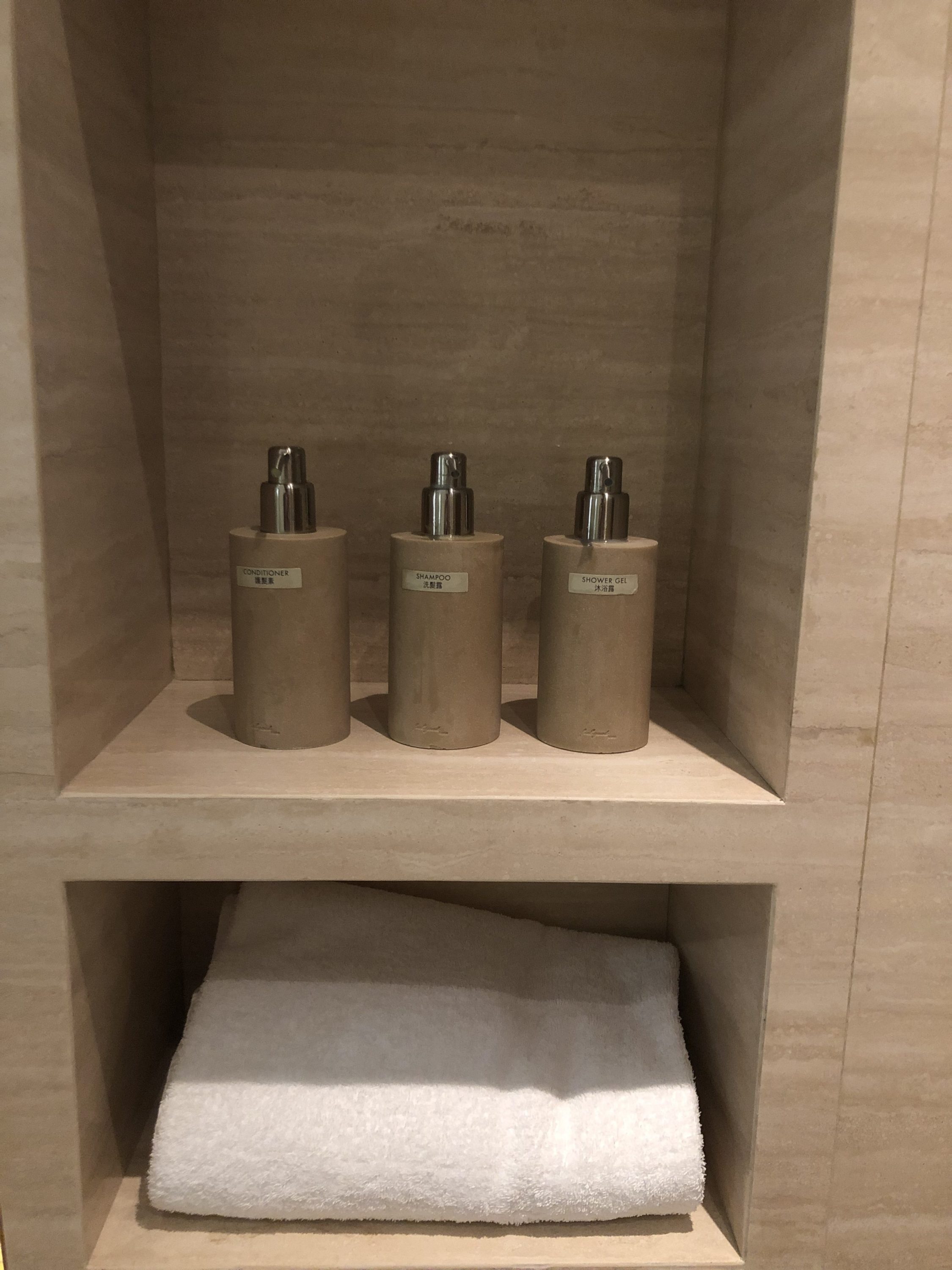 The Wing, First at Hong Kong International Airport cabana shower amenities and towel