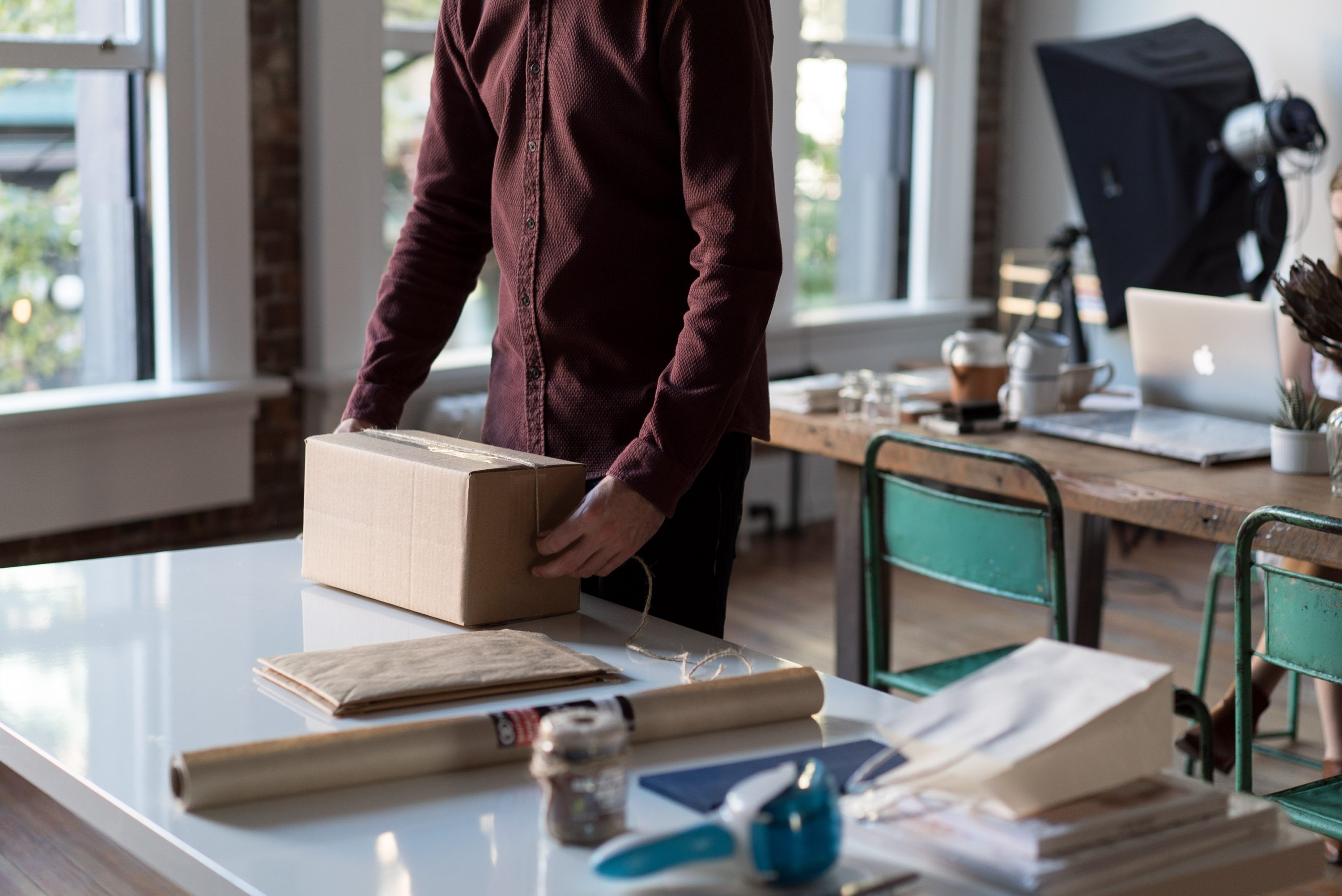 Man Holding A Brown Shipping Box
