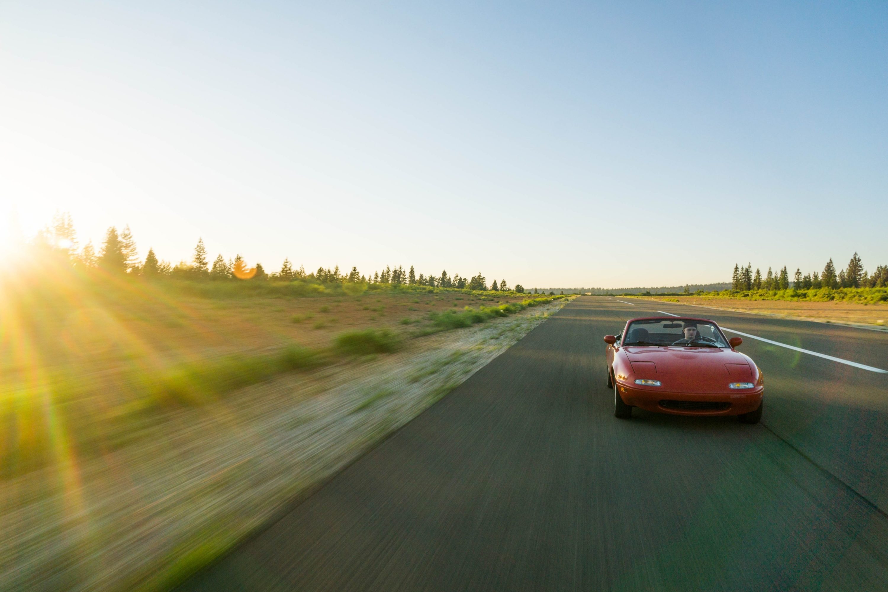 Miata car driving on road