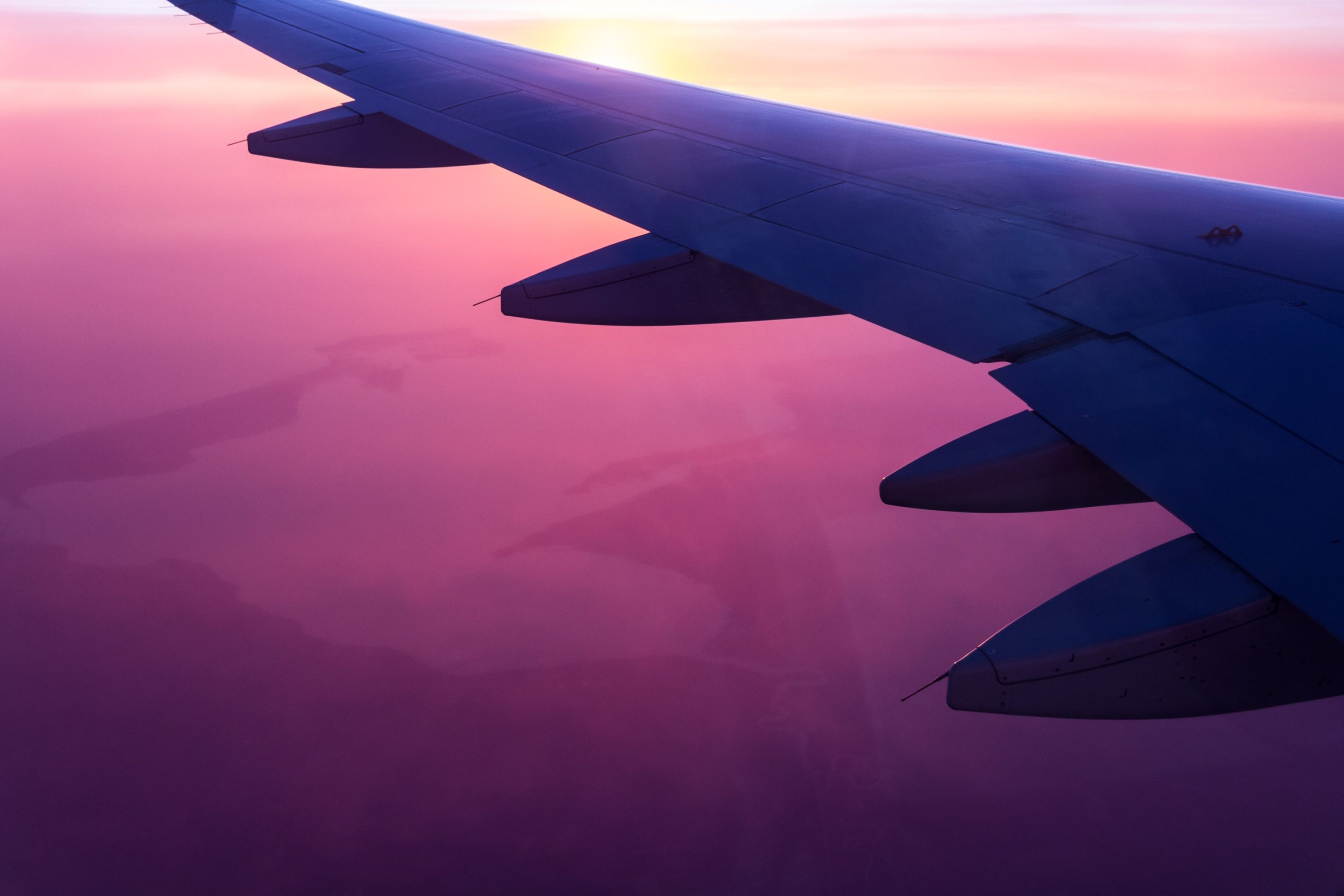 View Of A Pink Sky From An Airplane