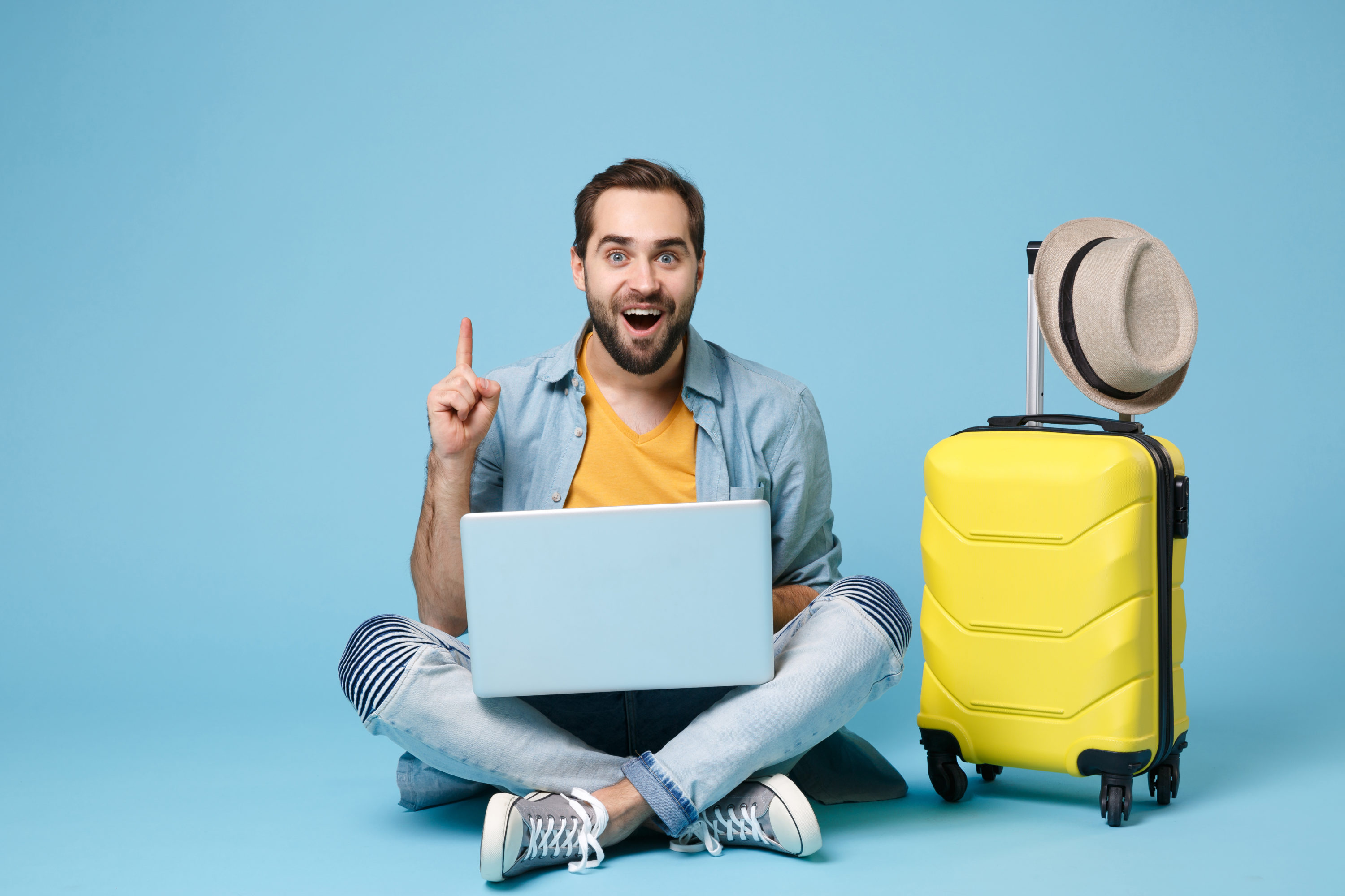 Man with carry on luggage and laptop