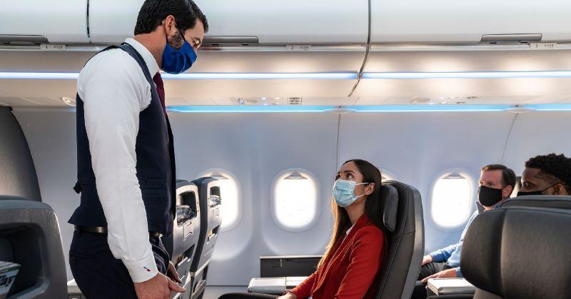 American Airlines masked flight attendant and passengers