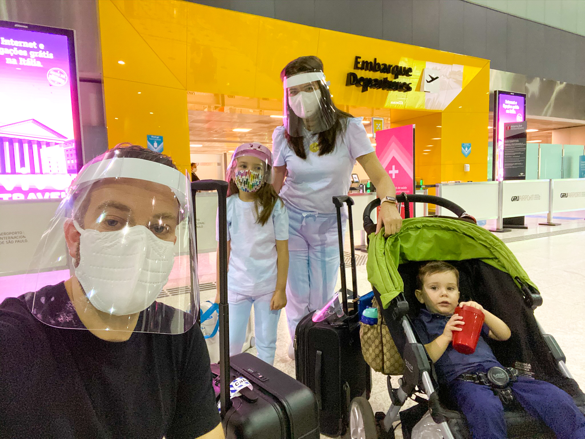 Family before airport security with face masks