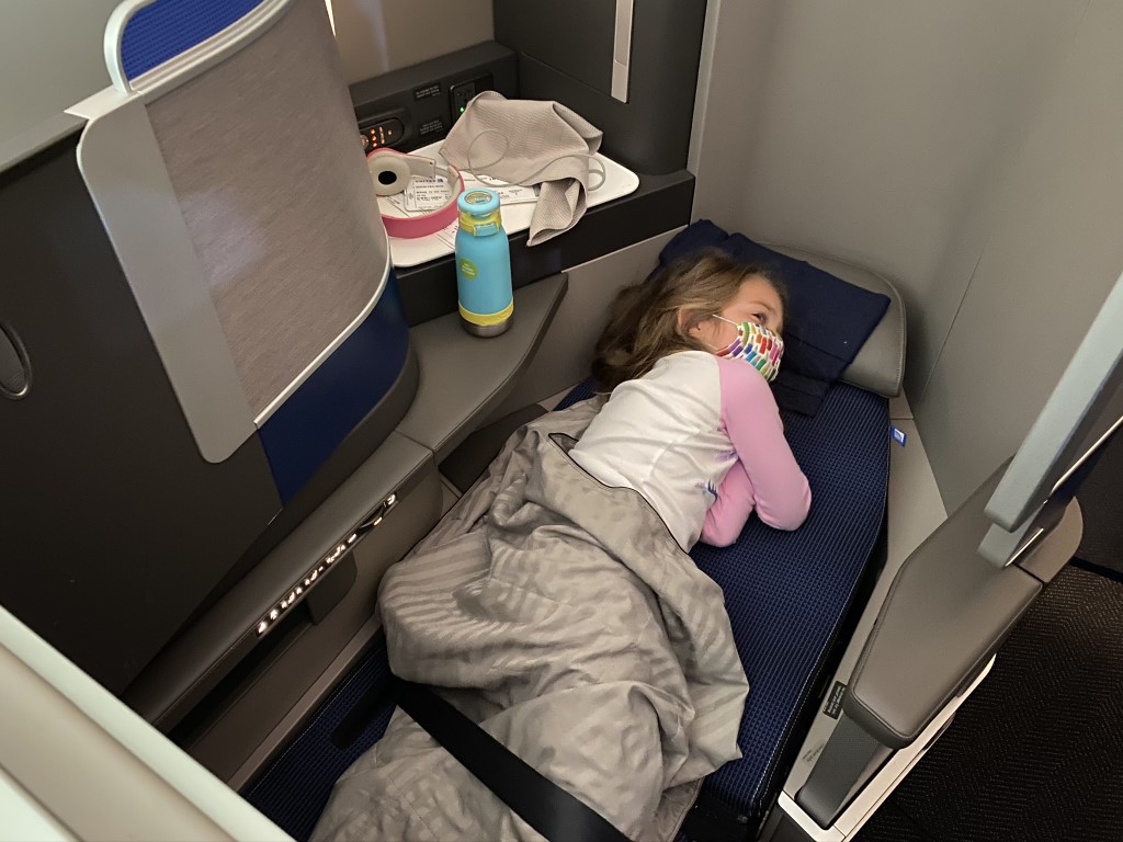 Girl sleeping in United Polaris lie flat bed Girl sleeping in United Polaris lie flat bed