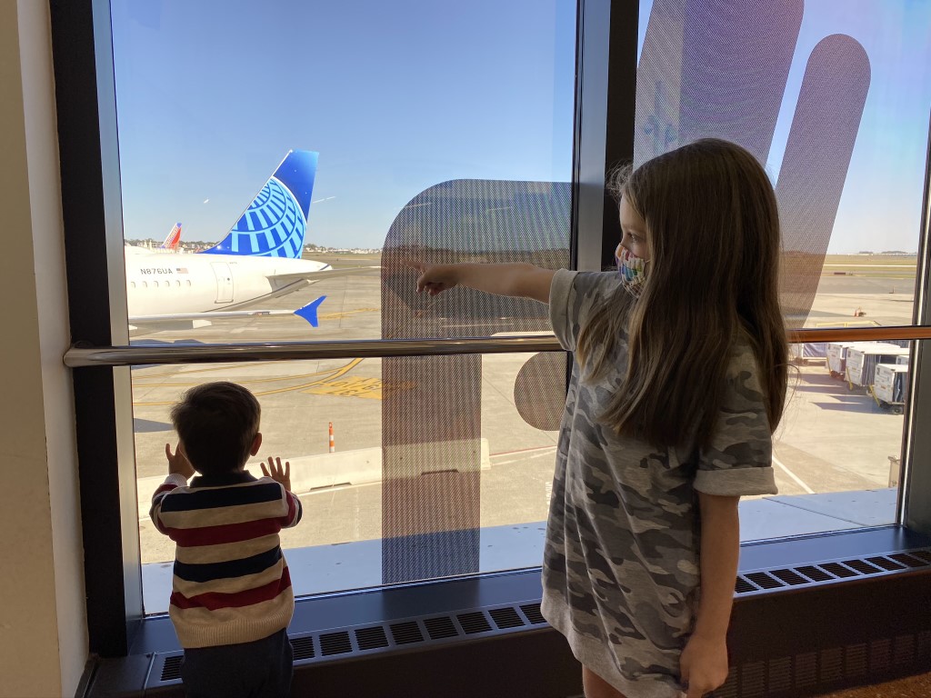 Kids looking at Boston Logan Airport BOS runway
