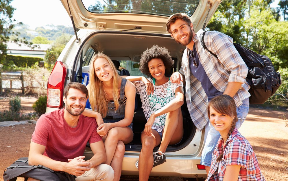 young adults outside of a van