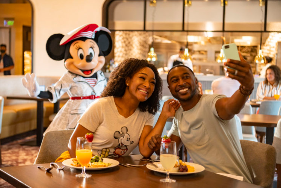 Couple having a character breakfast with Minnie Mouse at Topolinos Terrace at Disney World