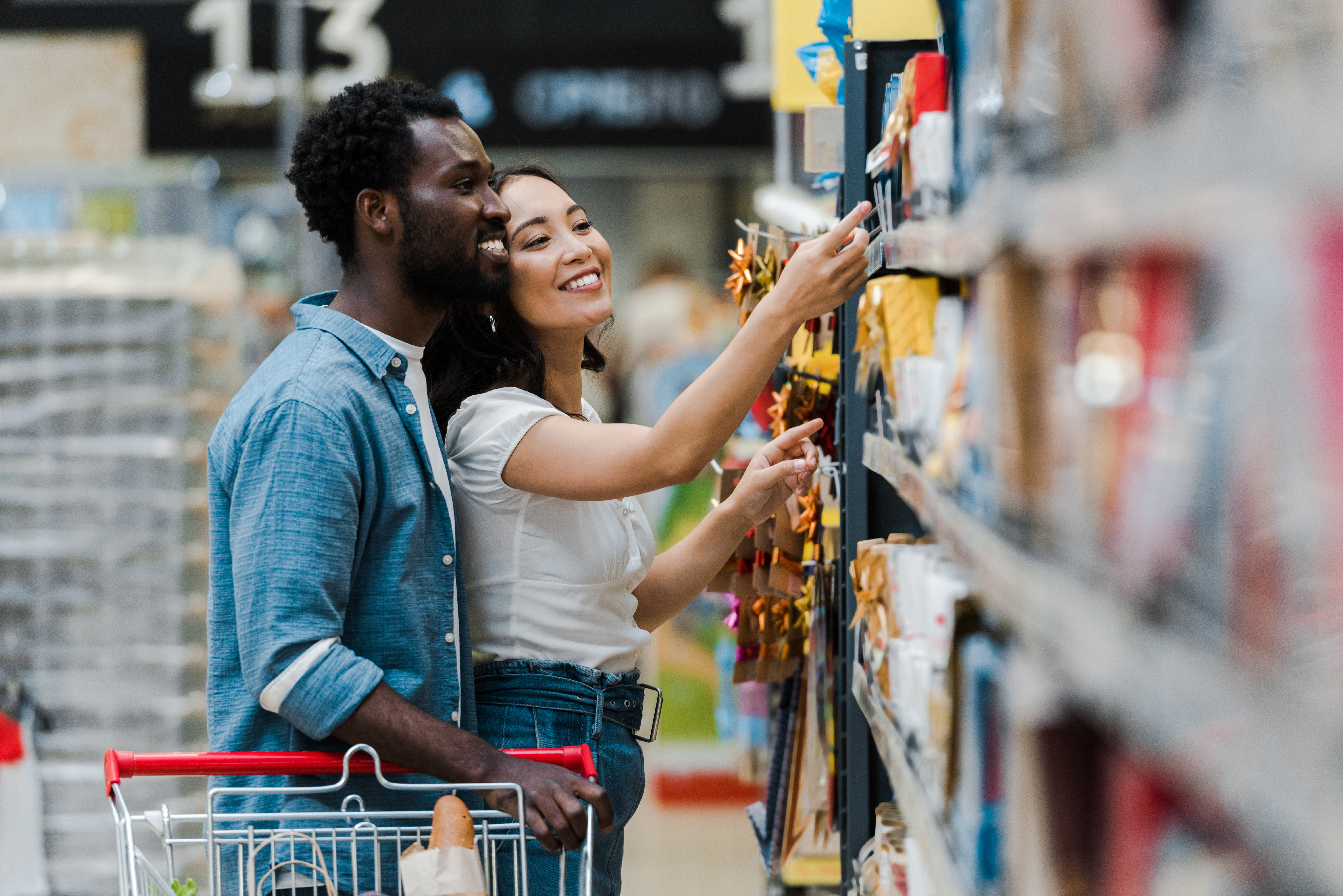 Couple grocery shopping at supermarket Couple grocery shopping at supermarket