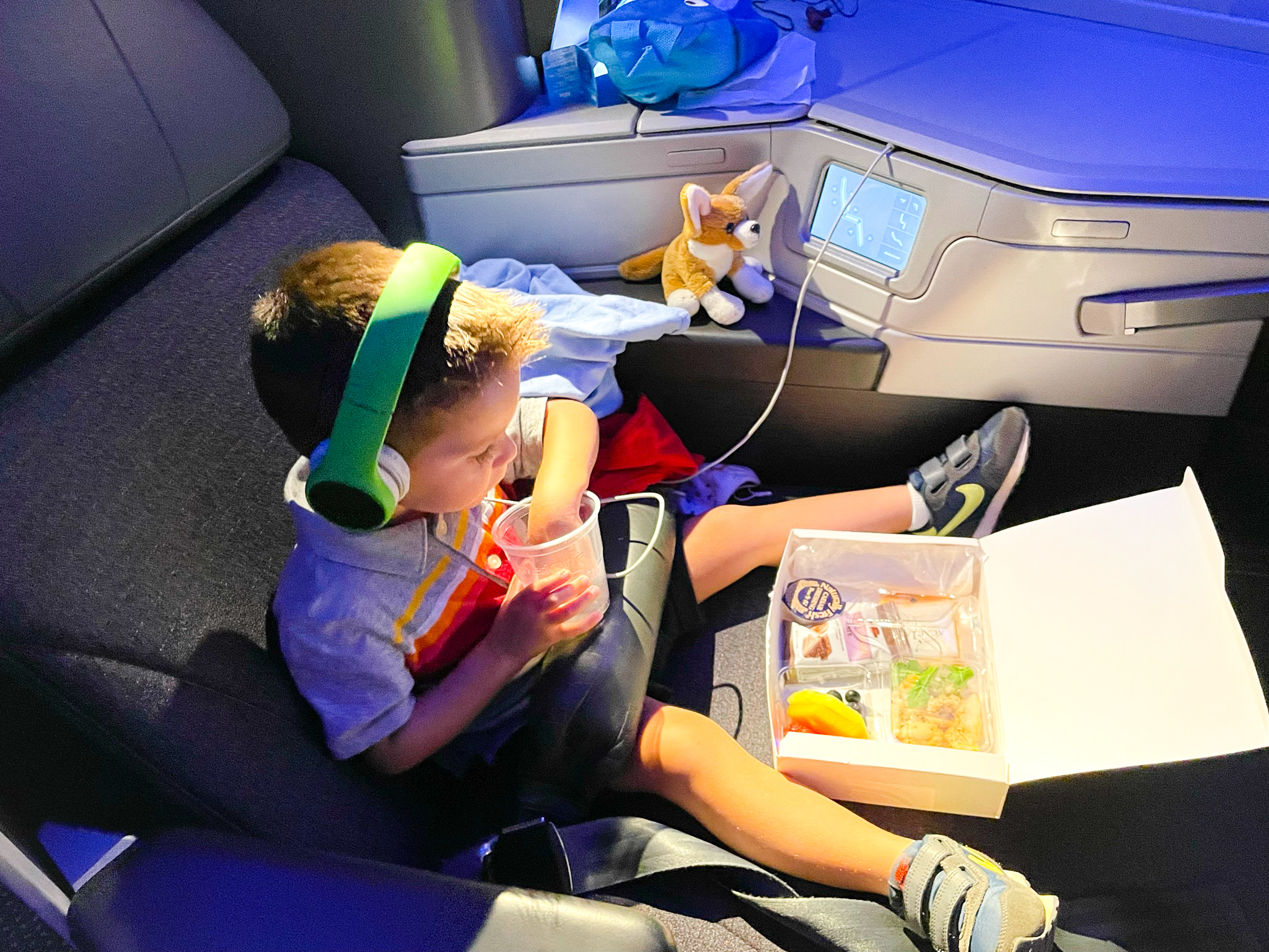 American Airlines First Flagship Business Class Miami to Boston boy eating snackbox