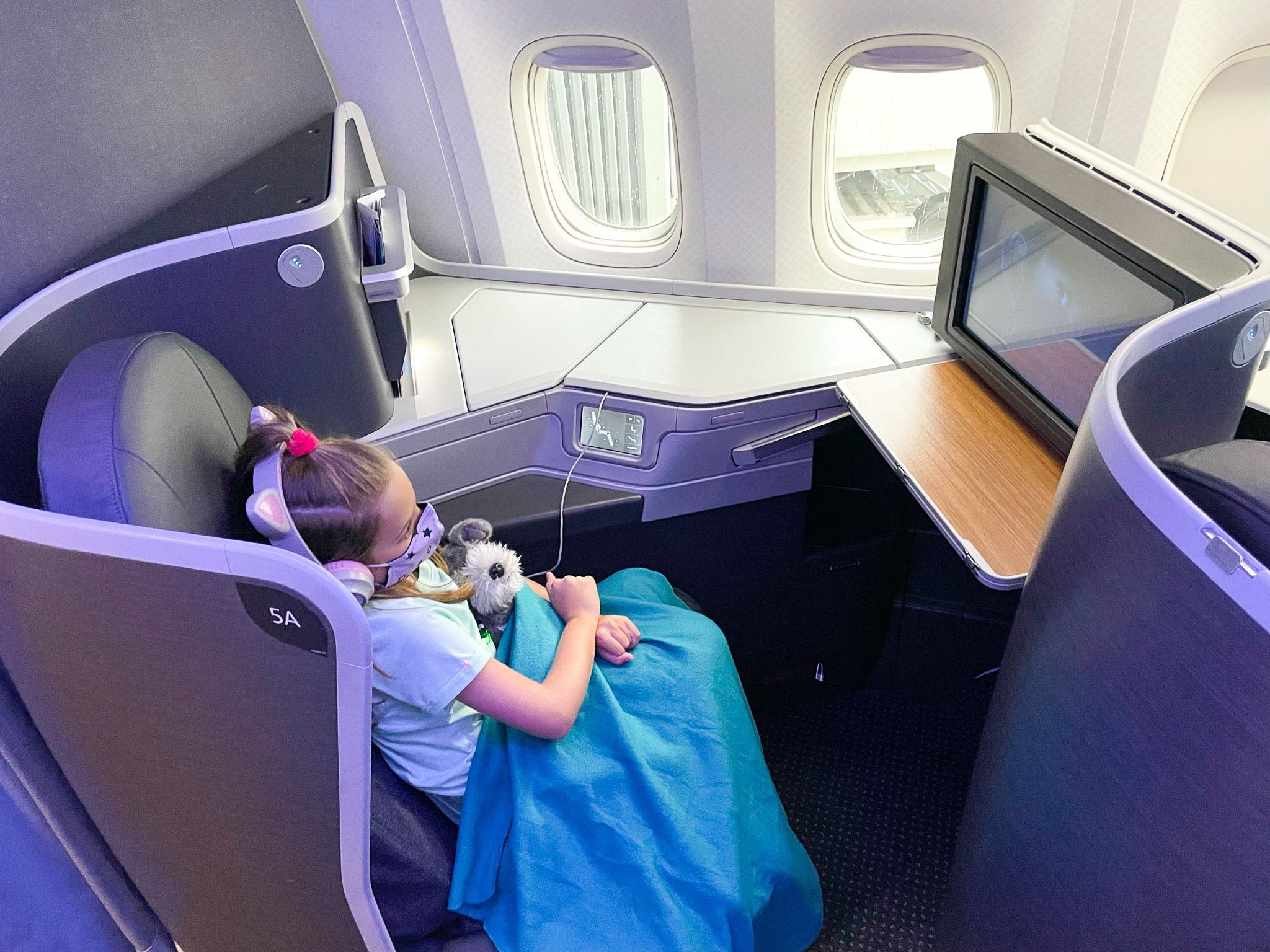 American Airlines First Flagship Business Class Miami to Boston girl watching tv