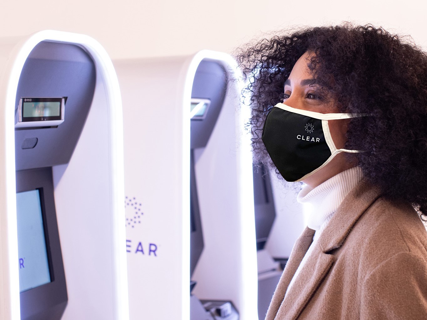 Woman in mask uses CLEAR