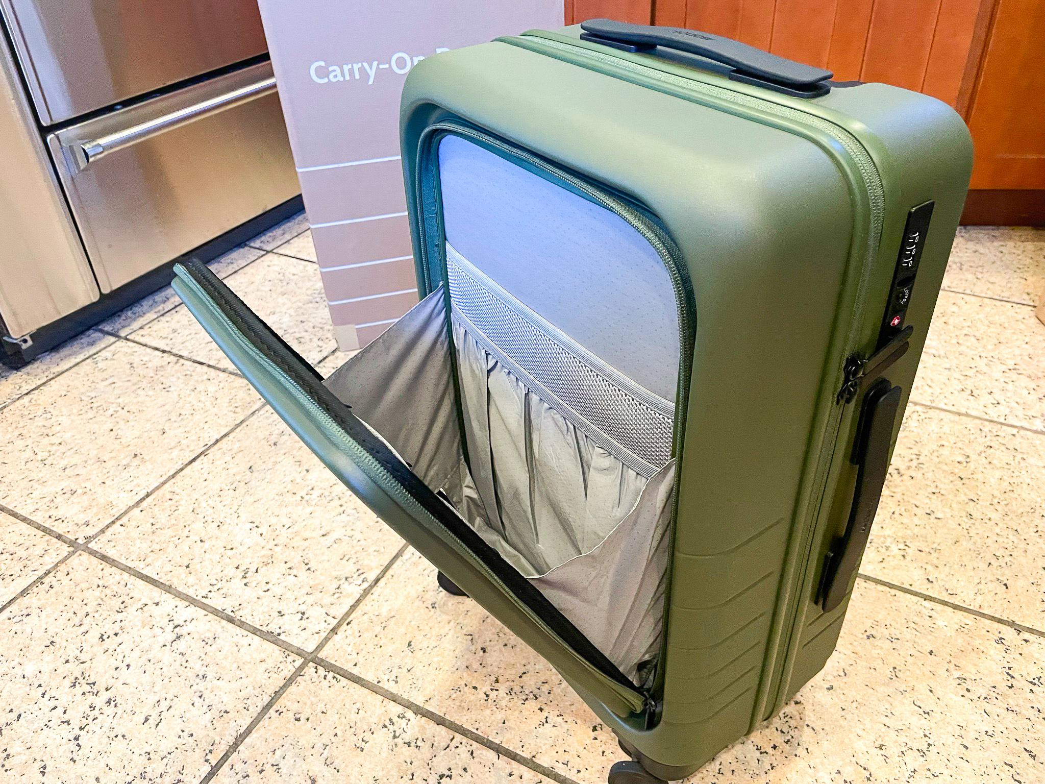 Olive Green Monos Luggage Carry On Pro front pocket