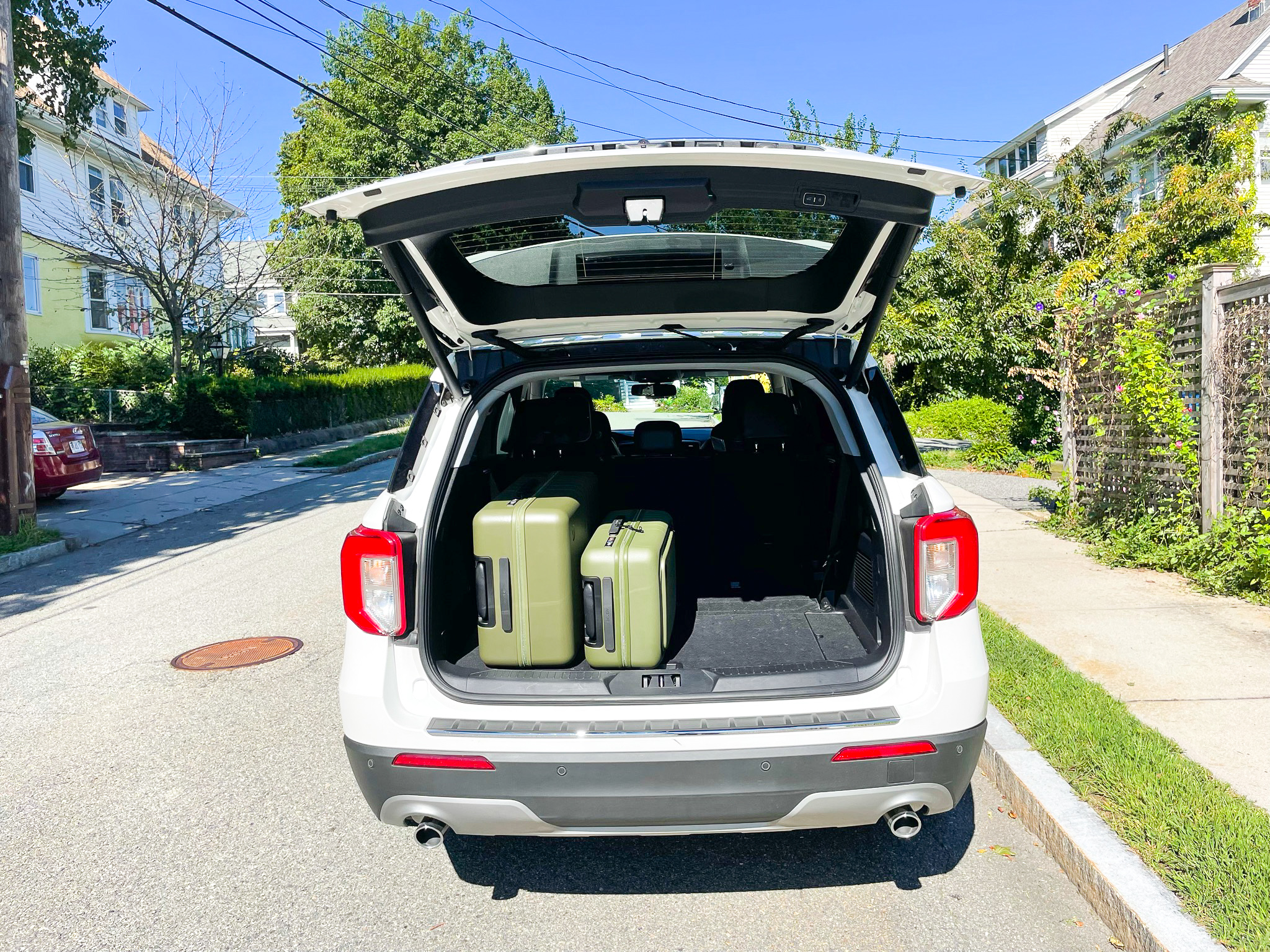 Olive Green Monos Luggage in a rental car Olive Green Monos Luggage in a rental car