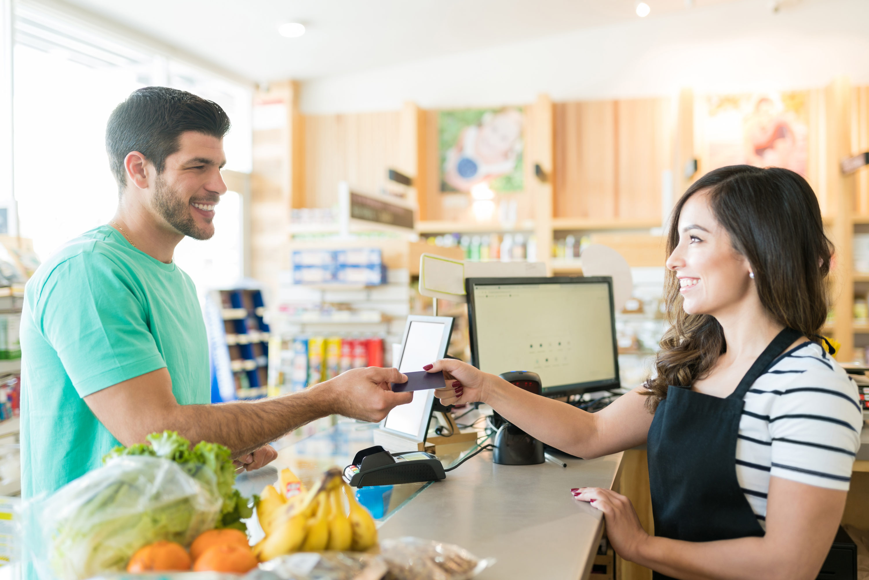 Man paying for groceries at supermarket