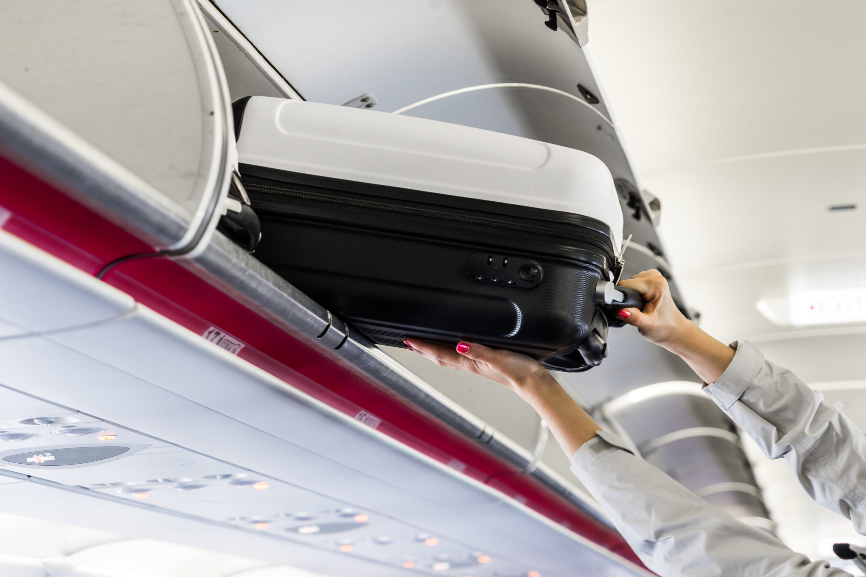 Putting luggage in the overhead bin.