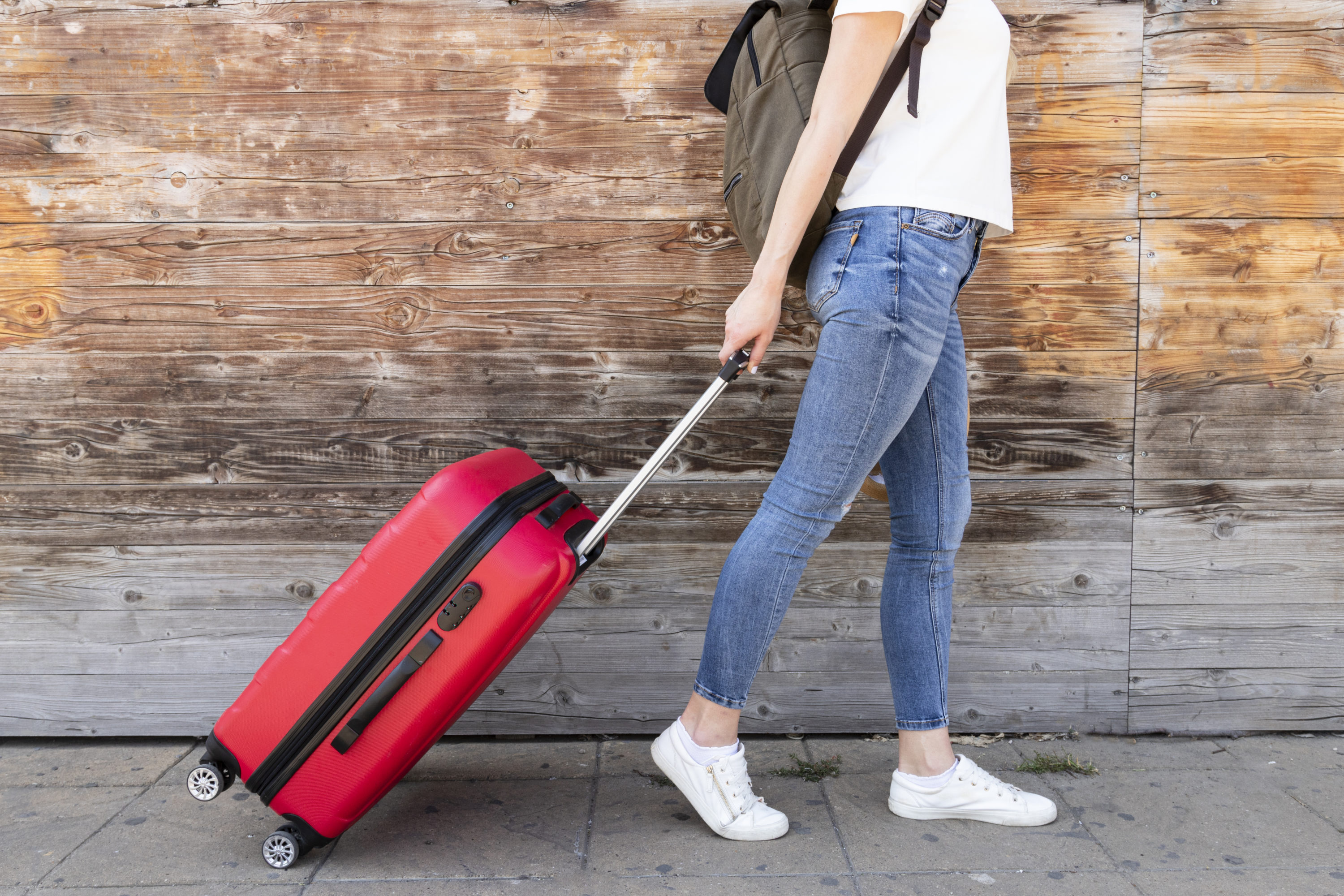 woman with red suitcase