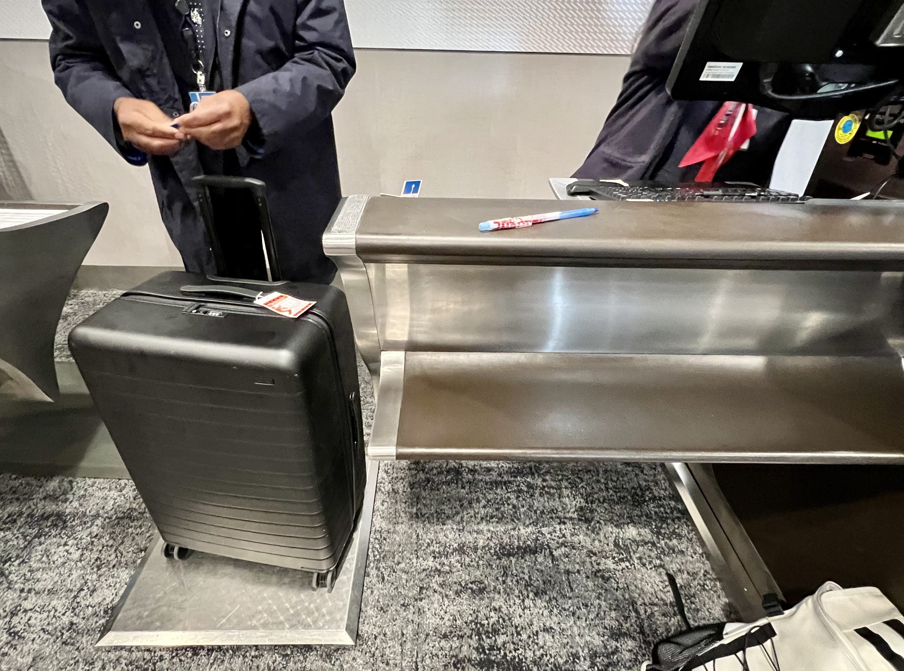 American Airlines Flagship First LAX case weighing and tagging