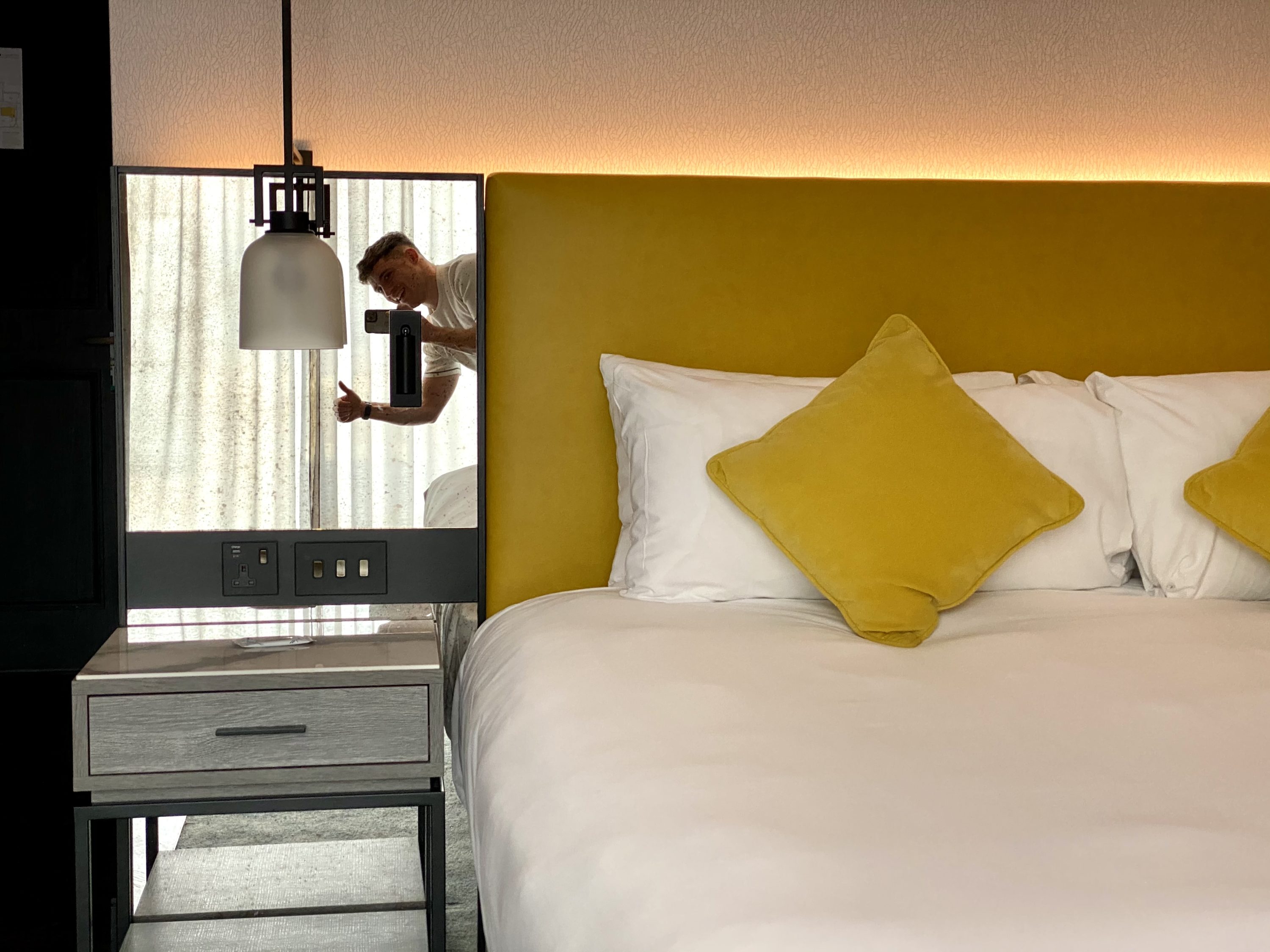 The Dixon London Autograph Collection bedroom bed and nightsand
