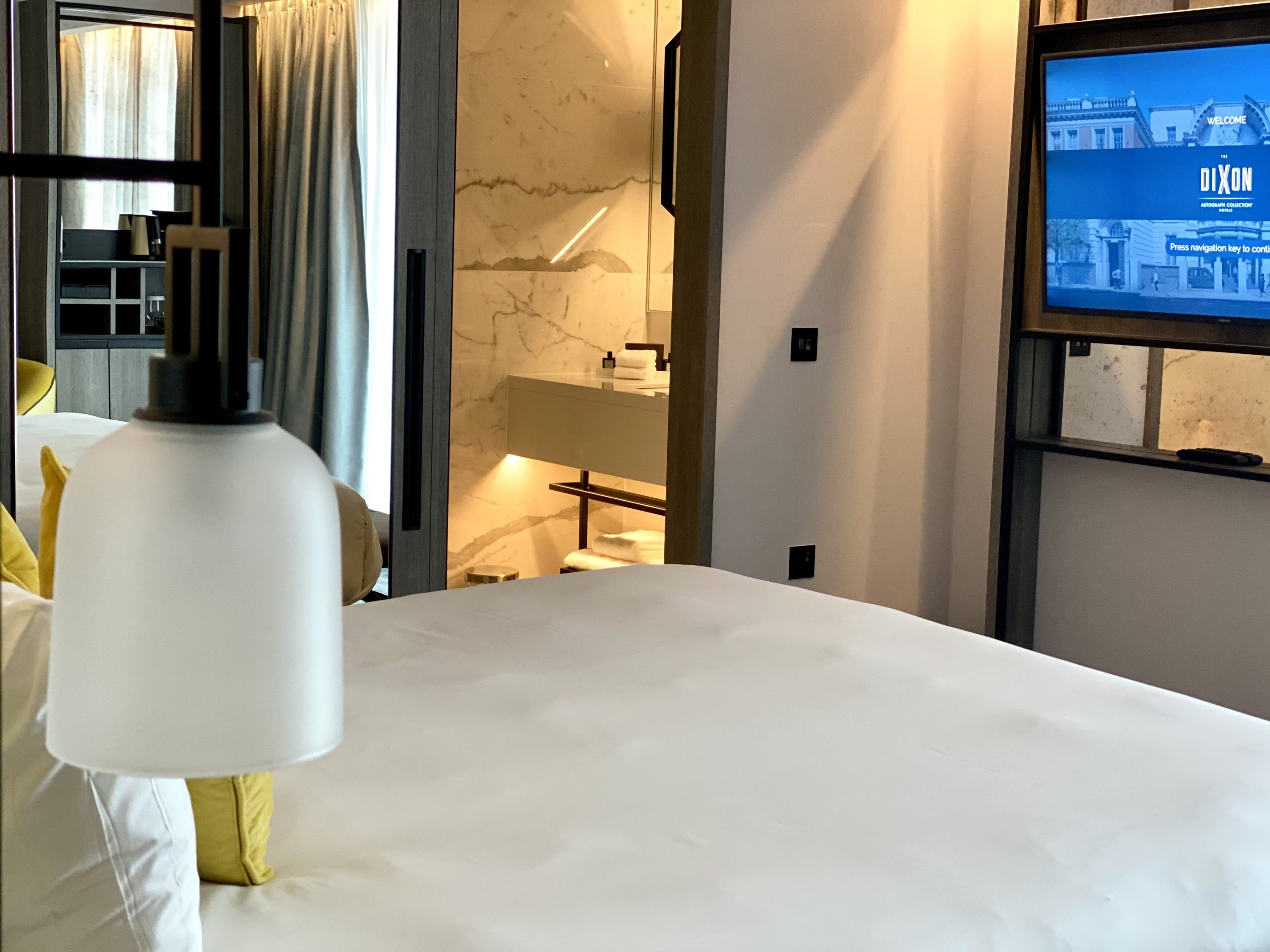 The Dixon London Autograph Collection bedroom view into bathroom
