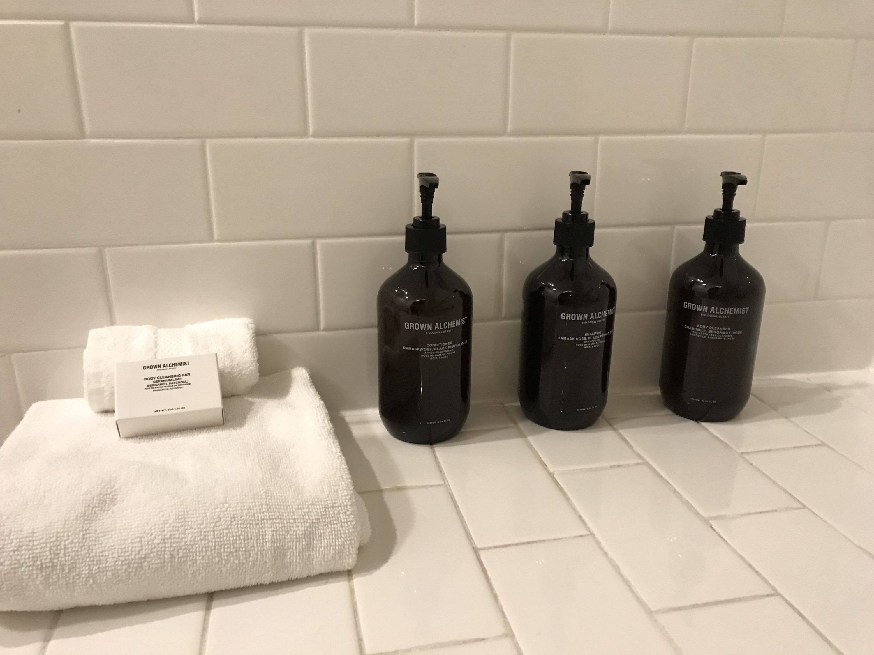 Refillable bottles of Grown Alchemist amenities in the Driskill bathroom