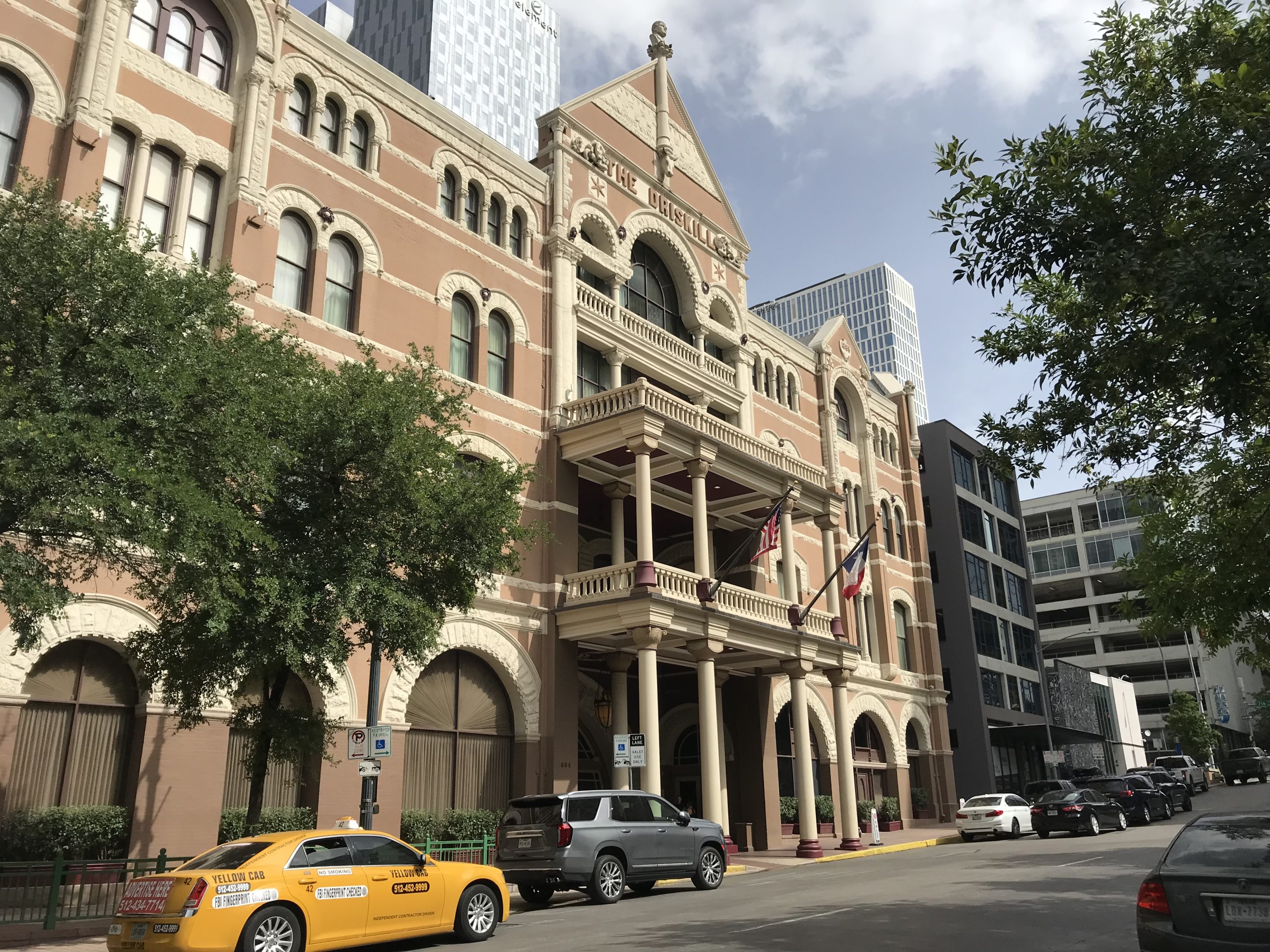 Brazos street entrance and valet station for The Driskill Hotel Austin.