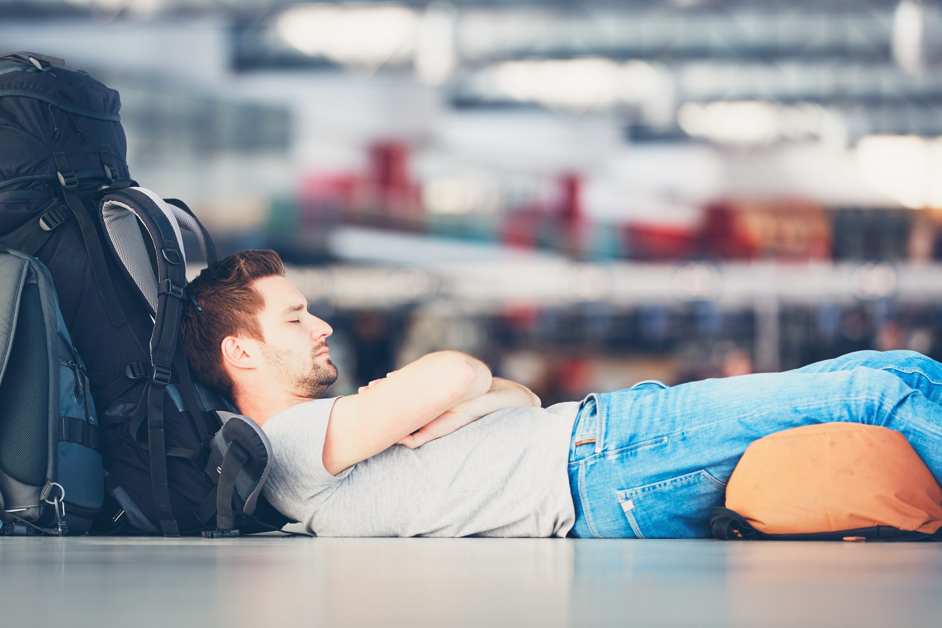 Traveler waiting at the airport departure area for his delayed flight