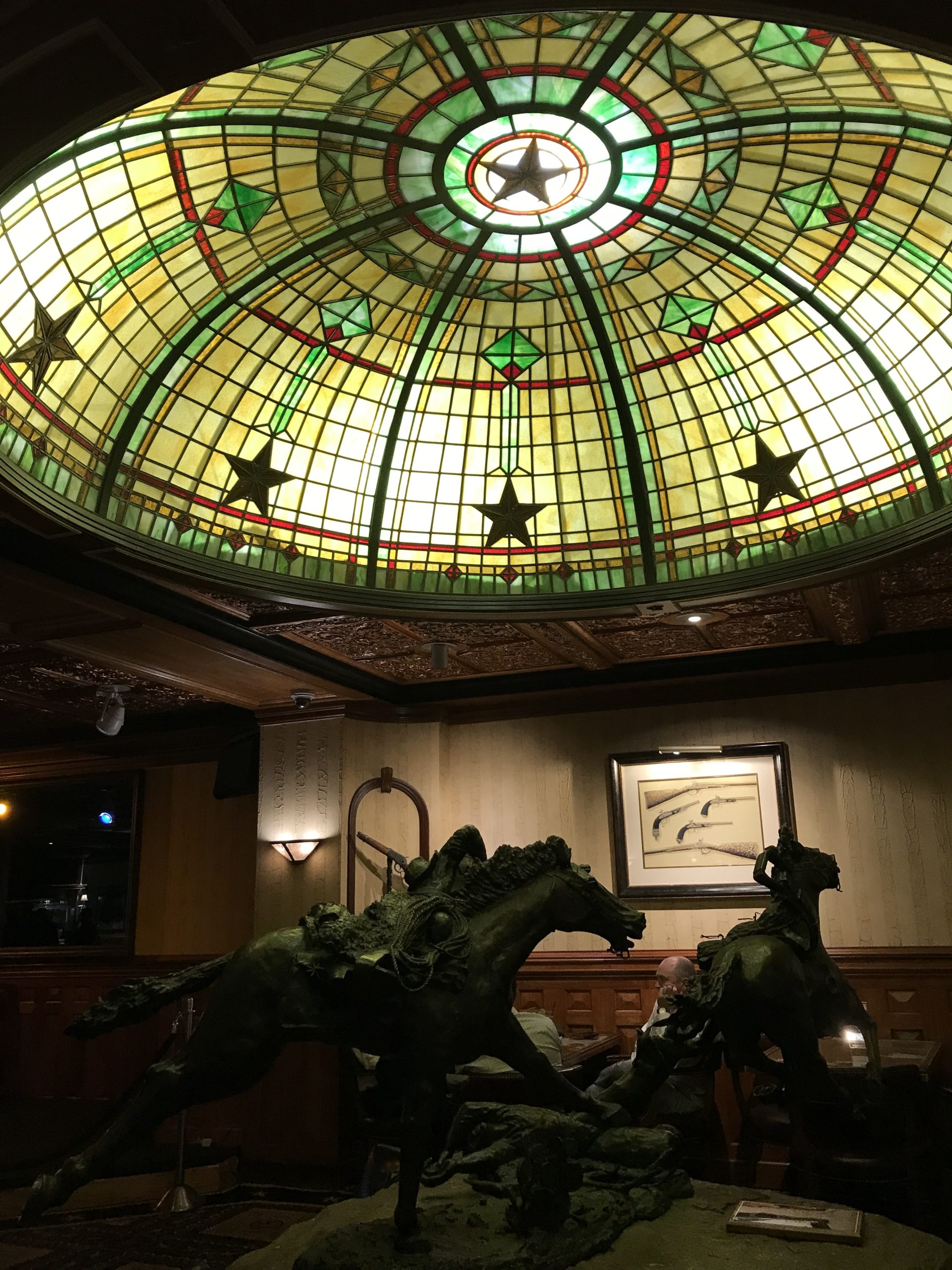 Horse statue and stained glass in The Driskill Bar