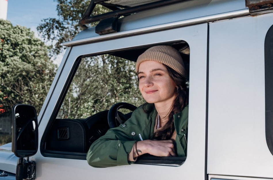 Young woman looking out car window