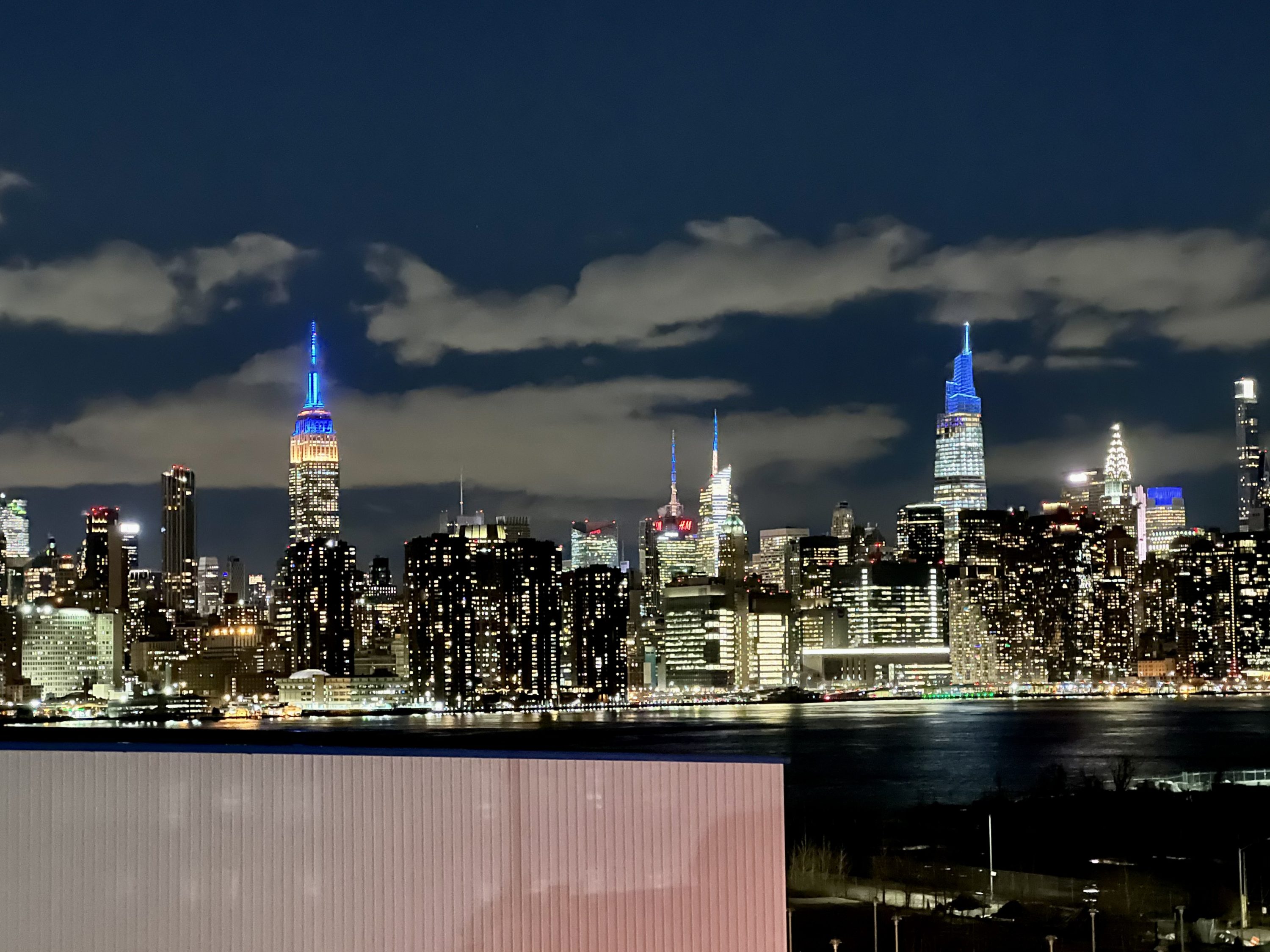 The Williamsburg Hotel bedroom Manhattan skyline by night
