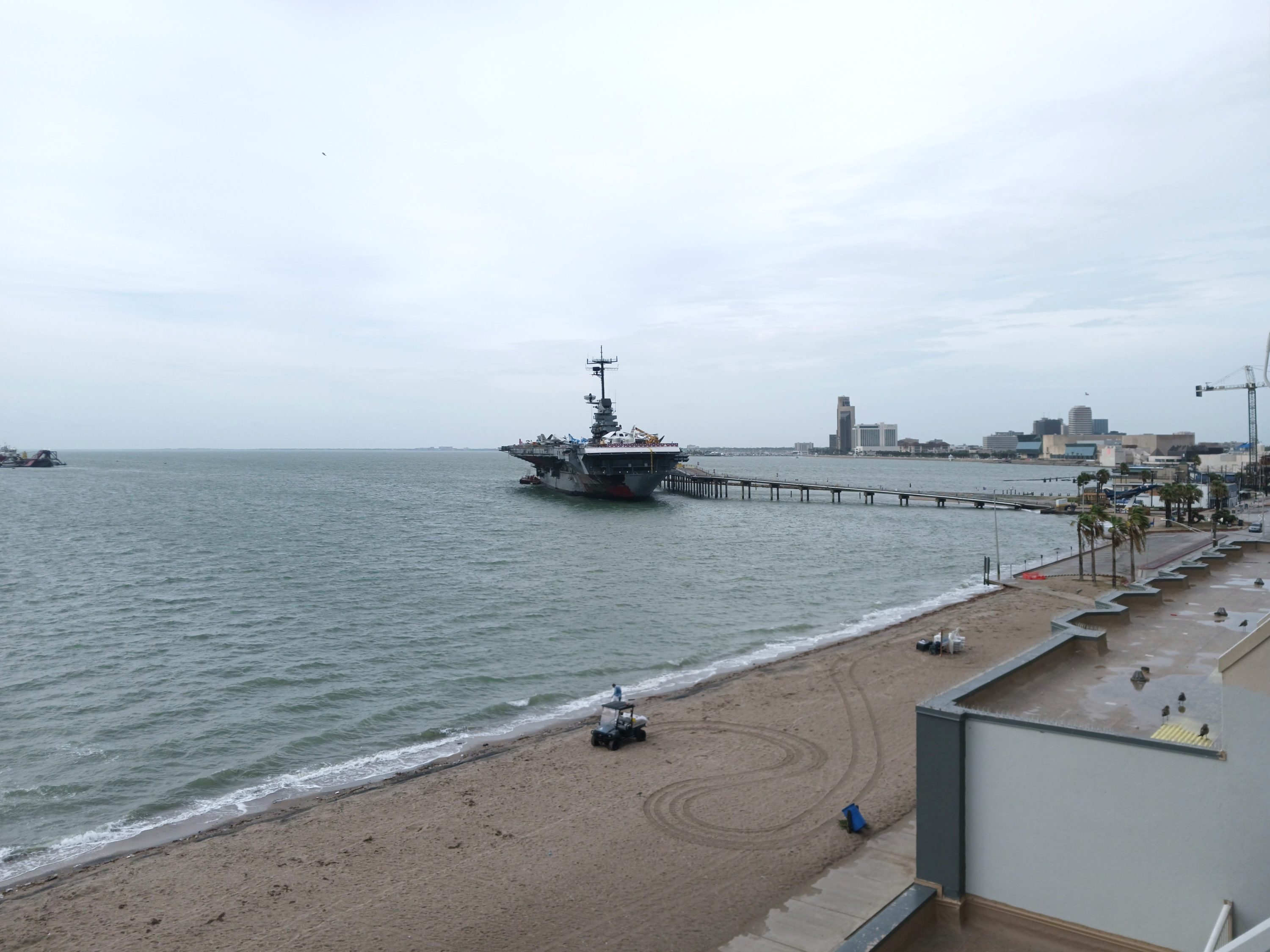 The Corpus Christi municipal maintenance workers cleaning trash on the beach at DoubleTree by Hilton Corpus Christi Beachfront