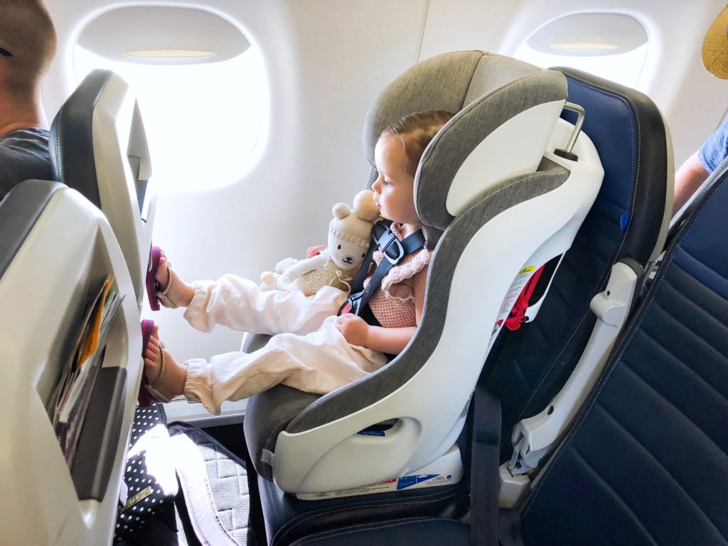 Child in Clek car seat on airplane Child in Clek car seat on airplane