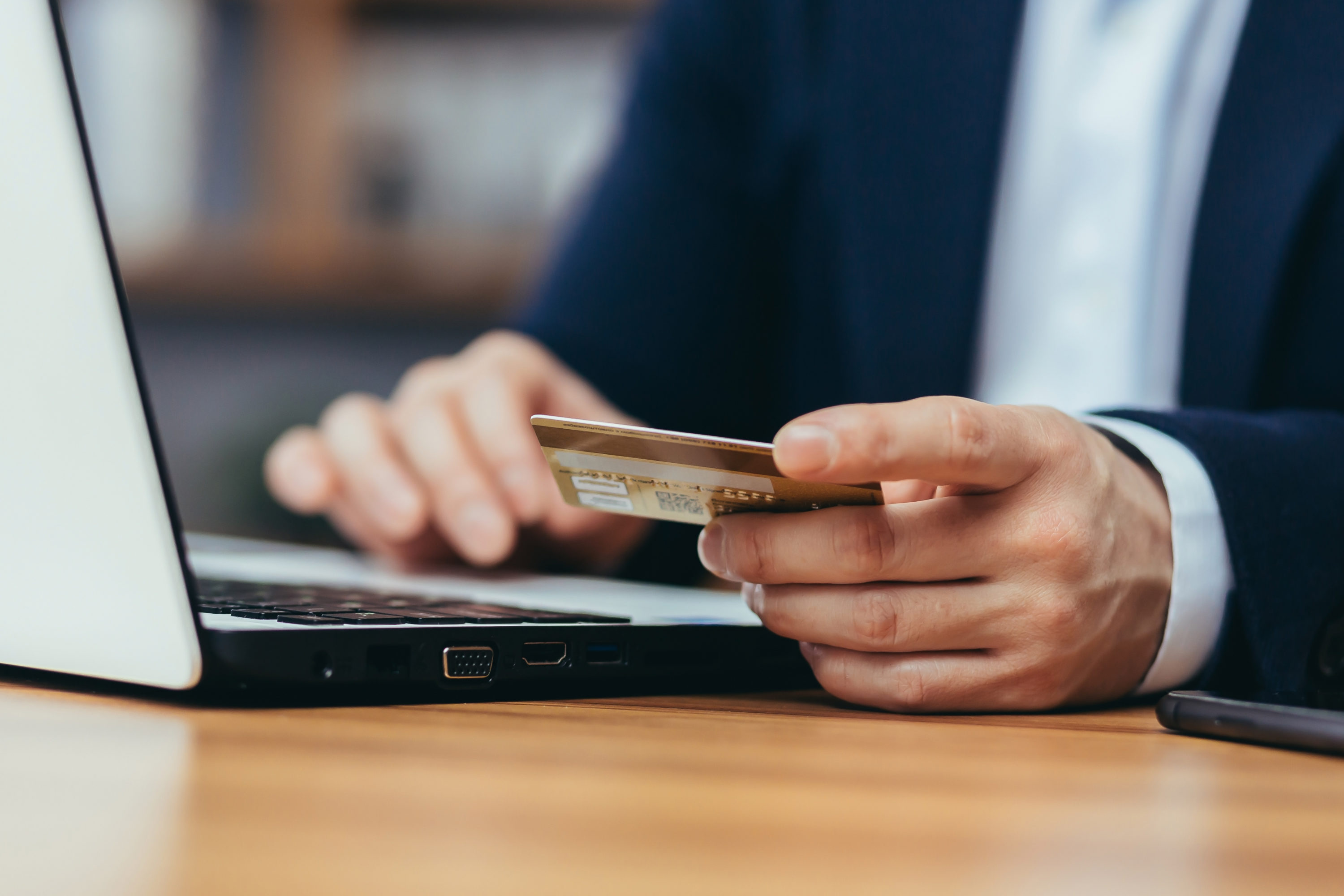 Close up of businessman online shopping with credit card