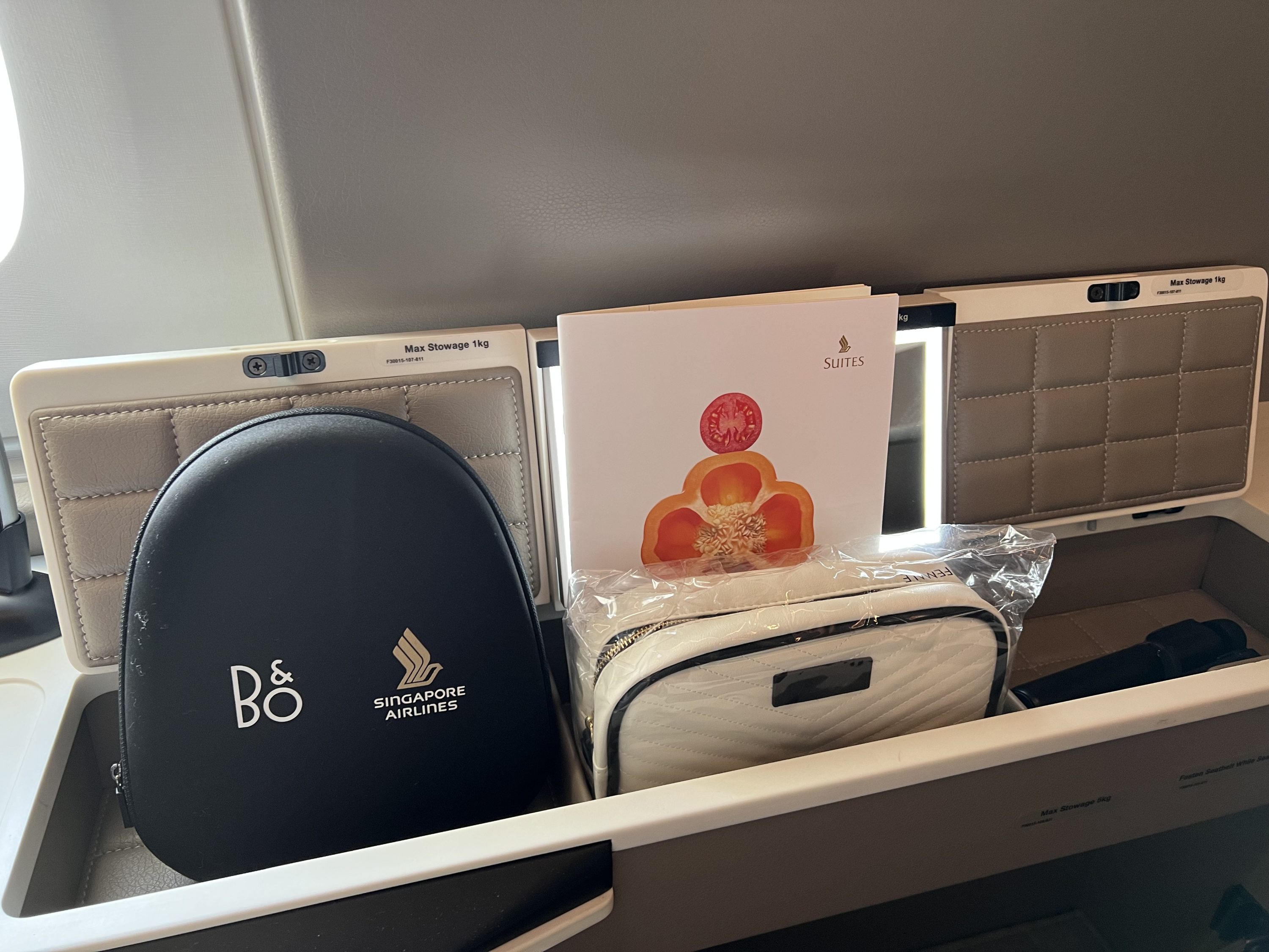 Singapore Suites amenity kit, headphones, and menu