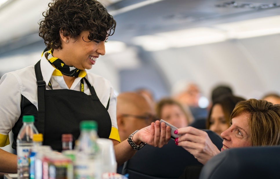 Spirit passenger buying item from flight attendant