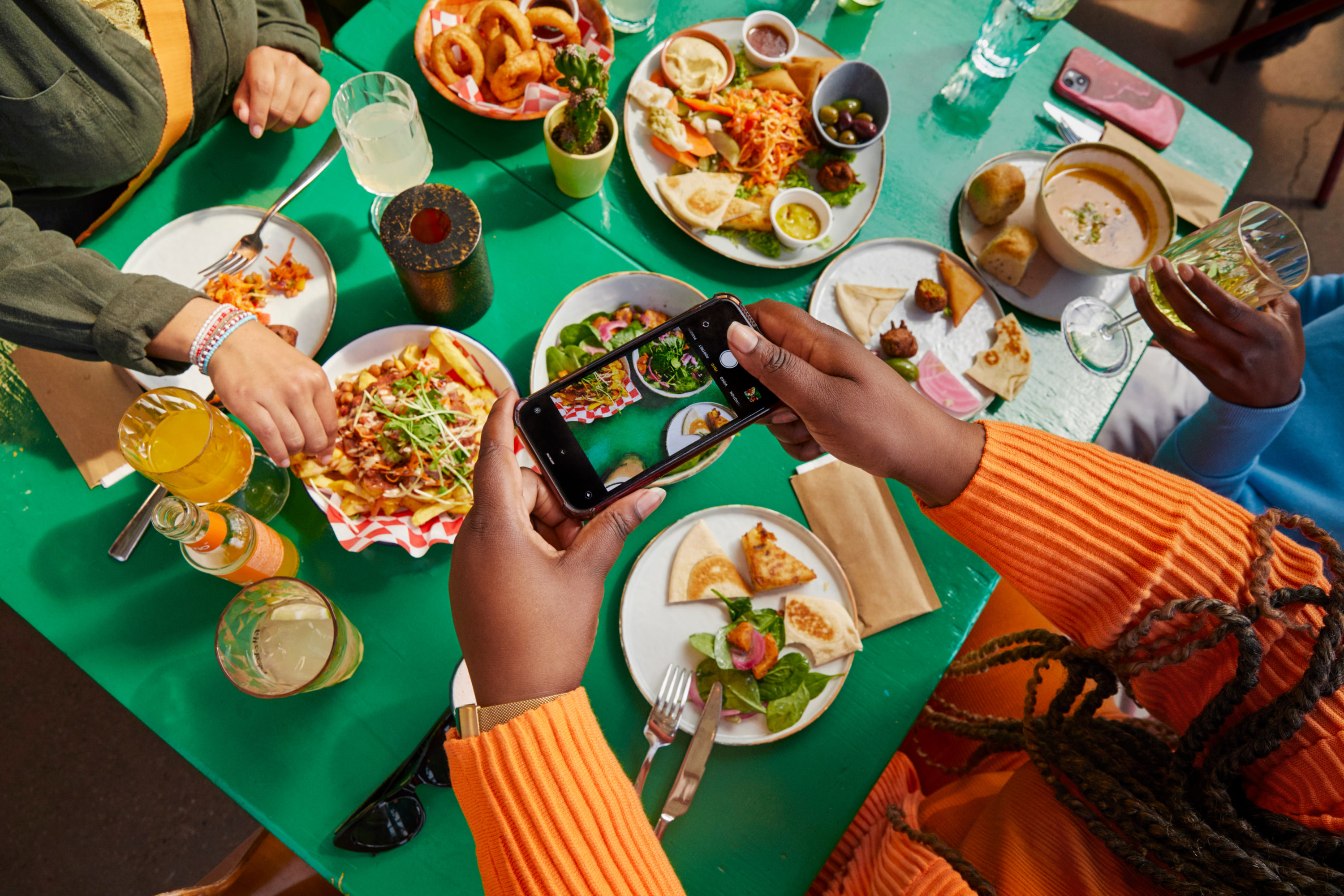 Women dining at restaurant taking picture Women dining at restaurant taking picture