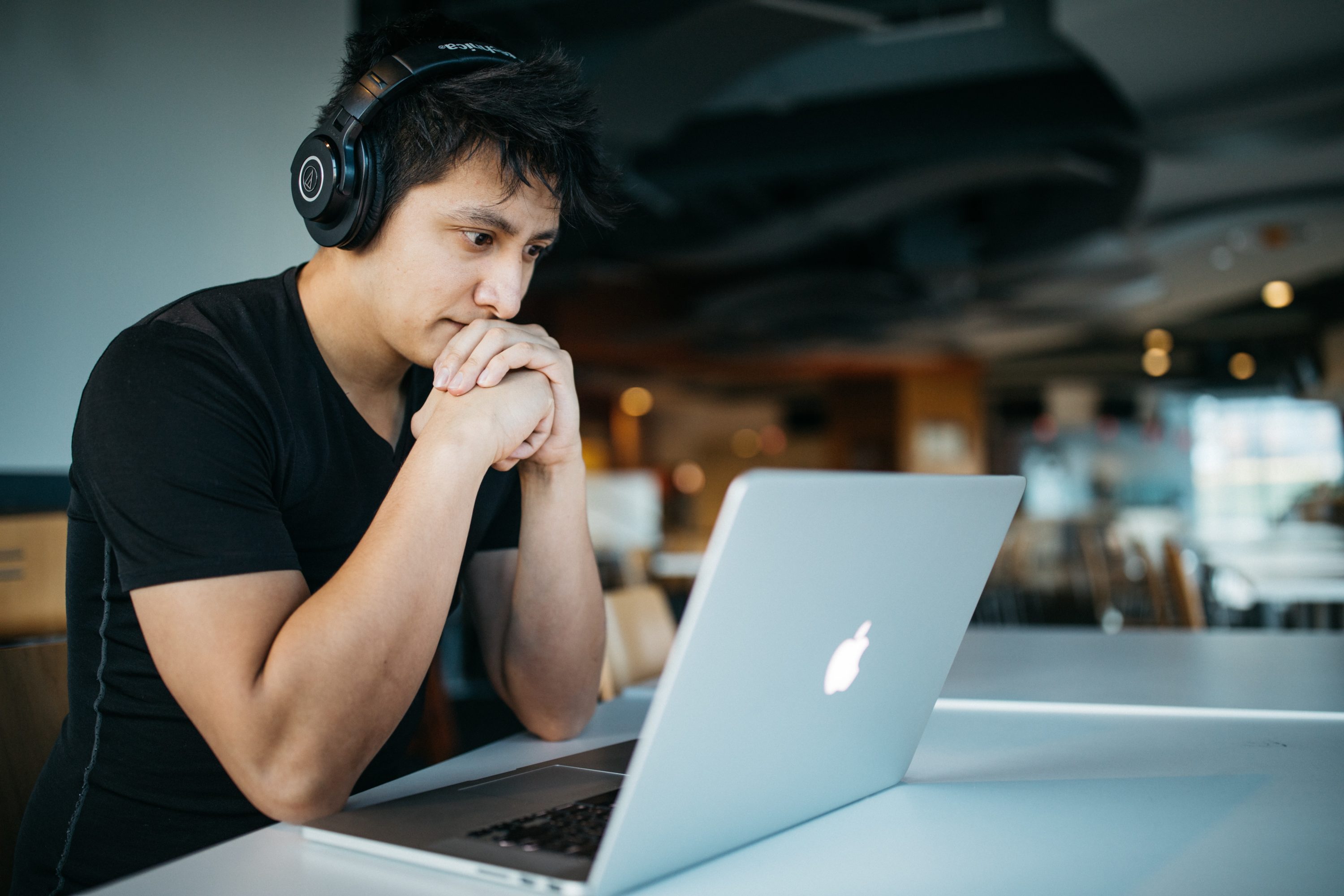Man sitting in front of laptop thinking