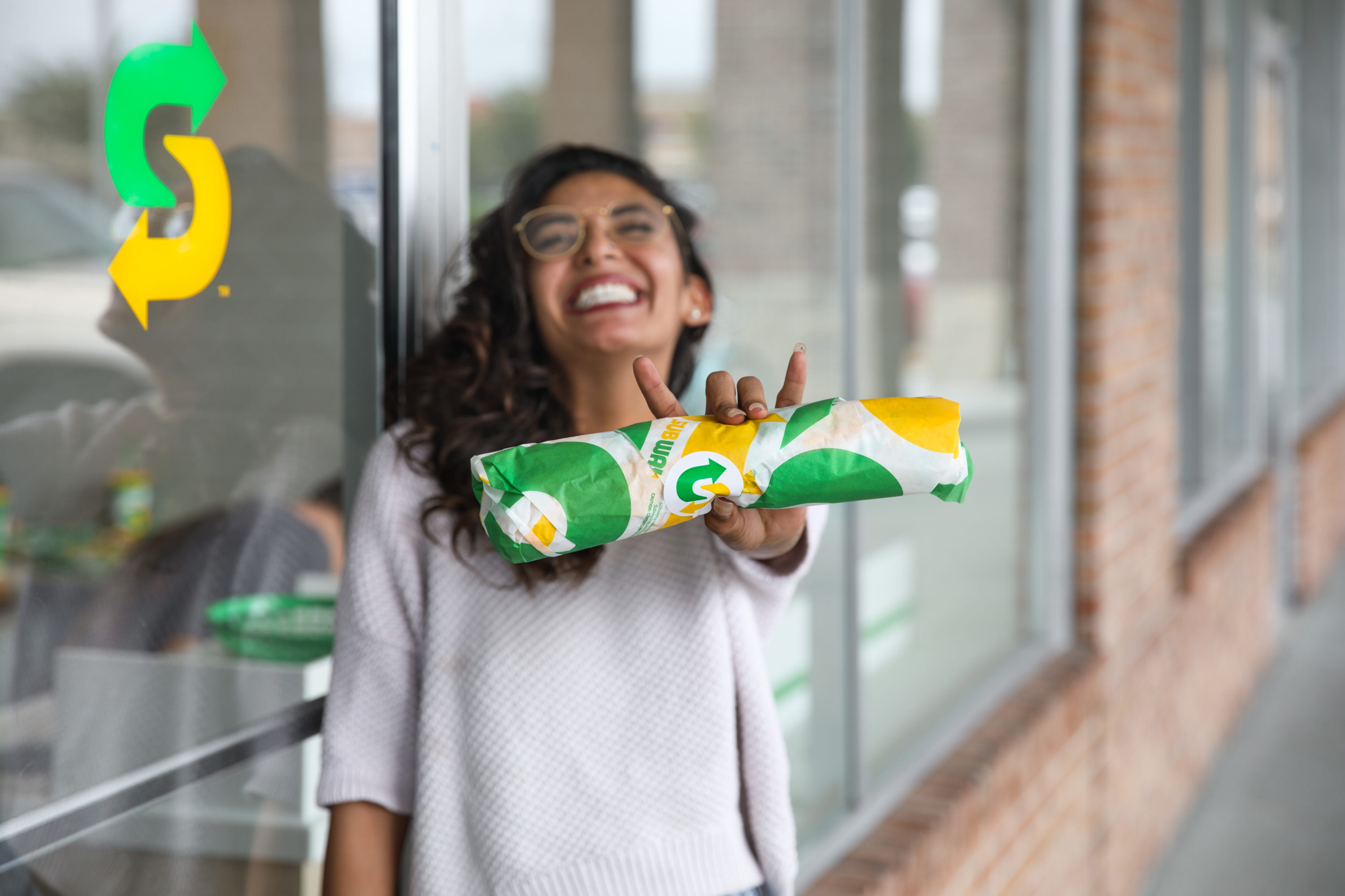 Woman holding Subway sandwich