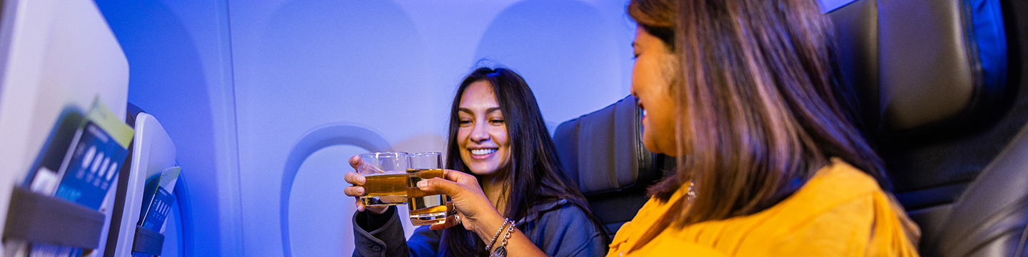 Alaska seatmates toasting