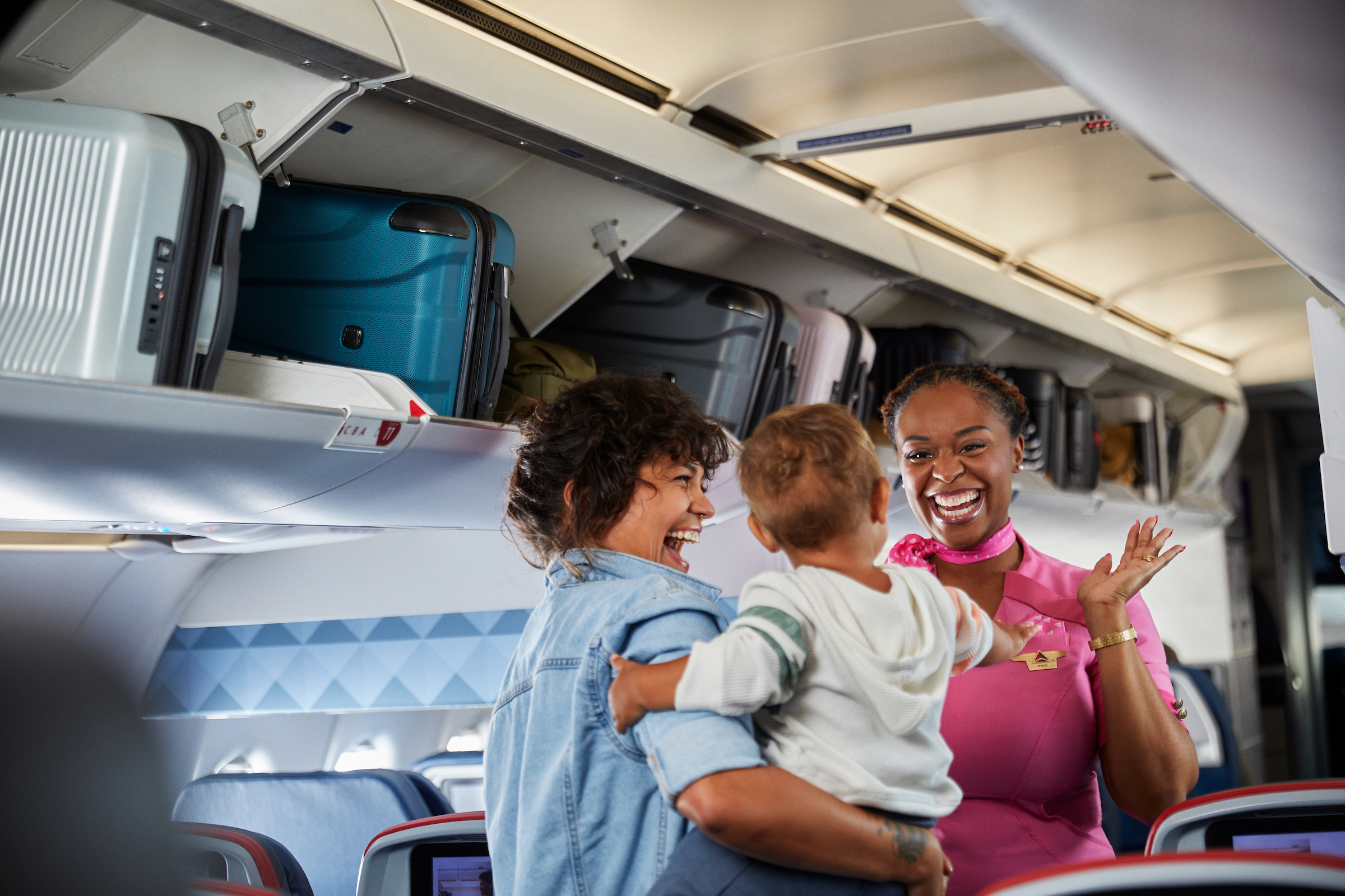 Delta flight attendant with woman and baby Delta flight attendant with woman and baby
