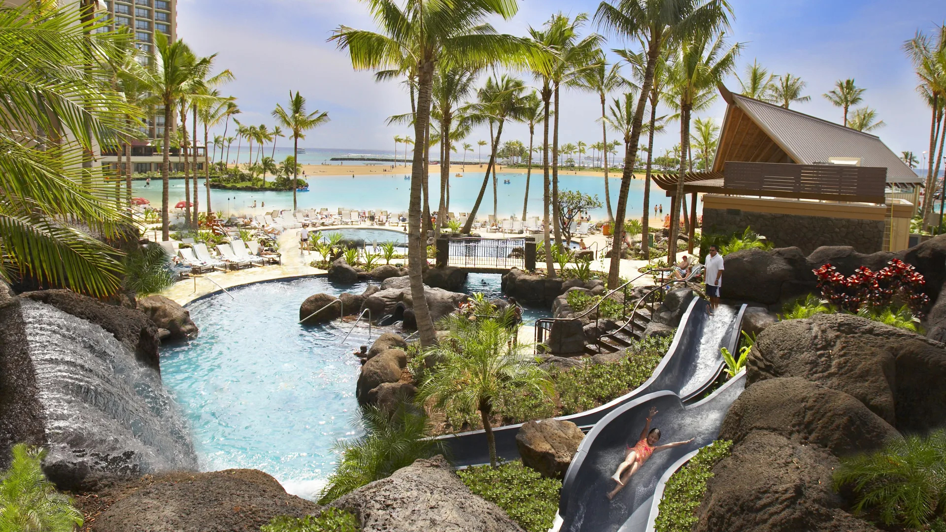 Girl slides down waterslide at Hilton Hawaiian Village Waikiki Beach Resort